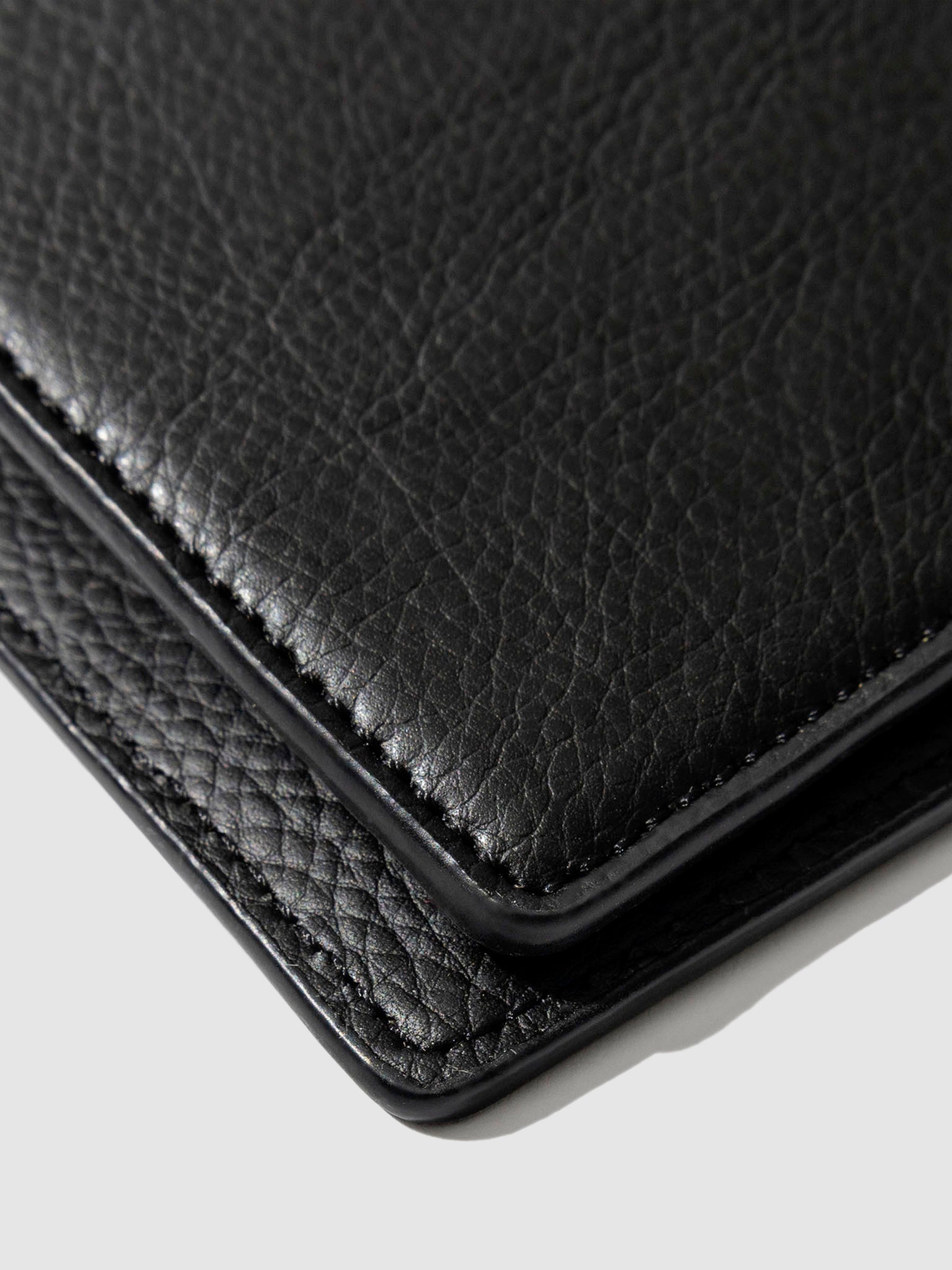Closeup of mesa black folio's textured vegan leather.
