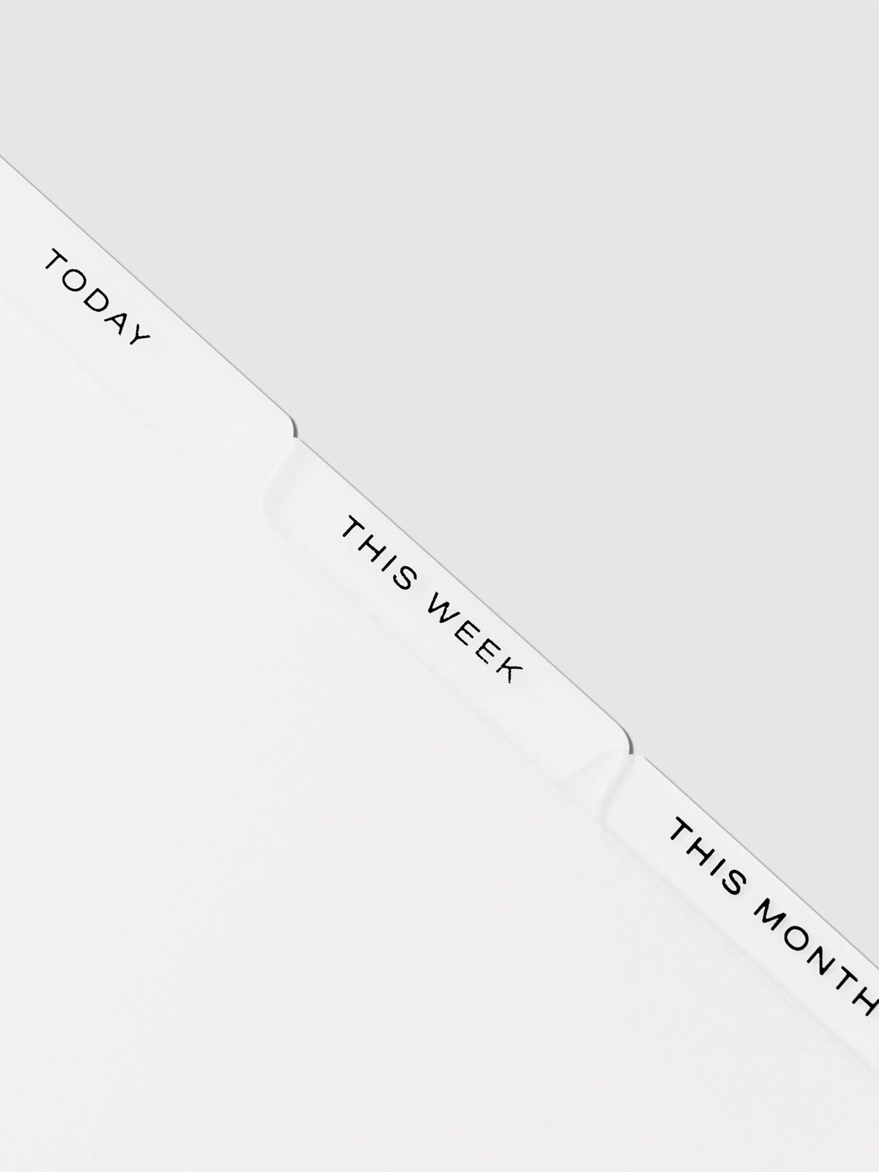 Closeup of black foil dividers on a neutral background. From left to right, they read Today / This Week / This Month.