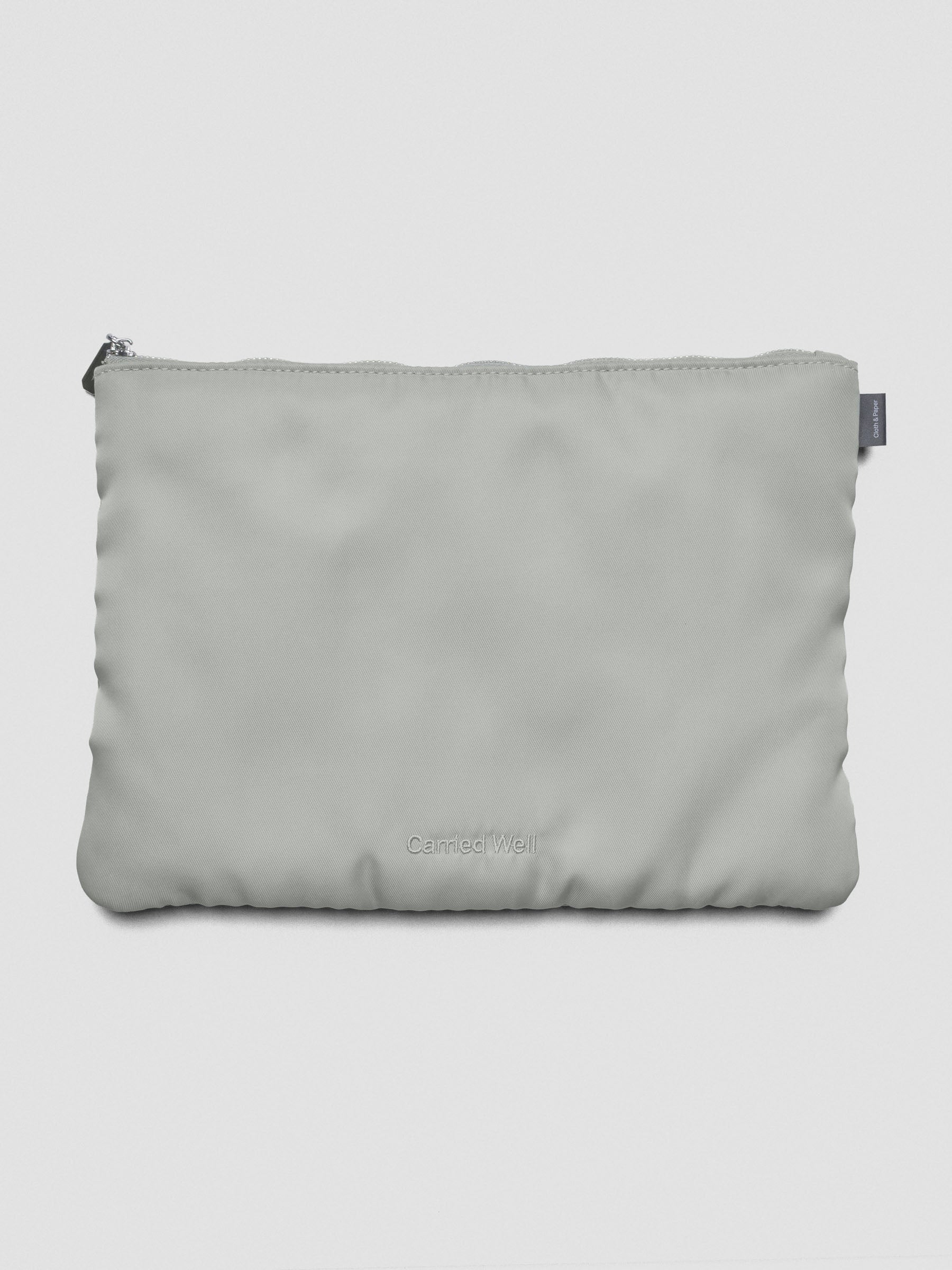 Light green-grey nylon, zippered, padded travel case.