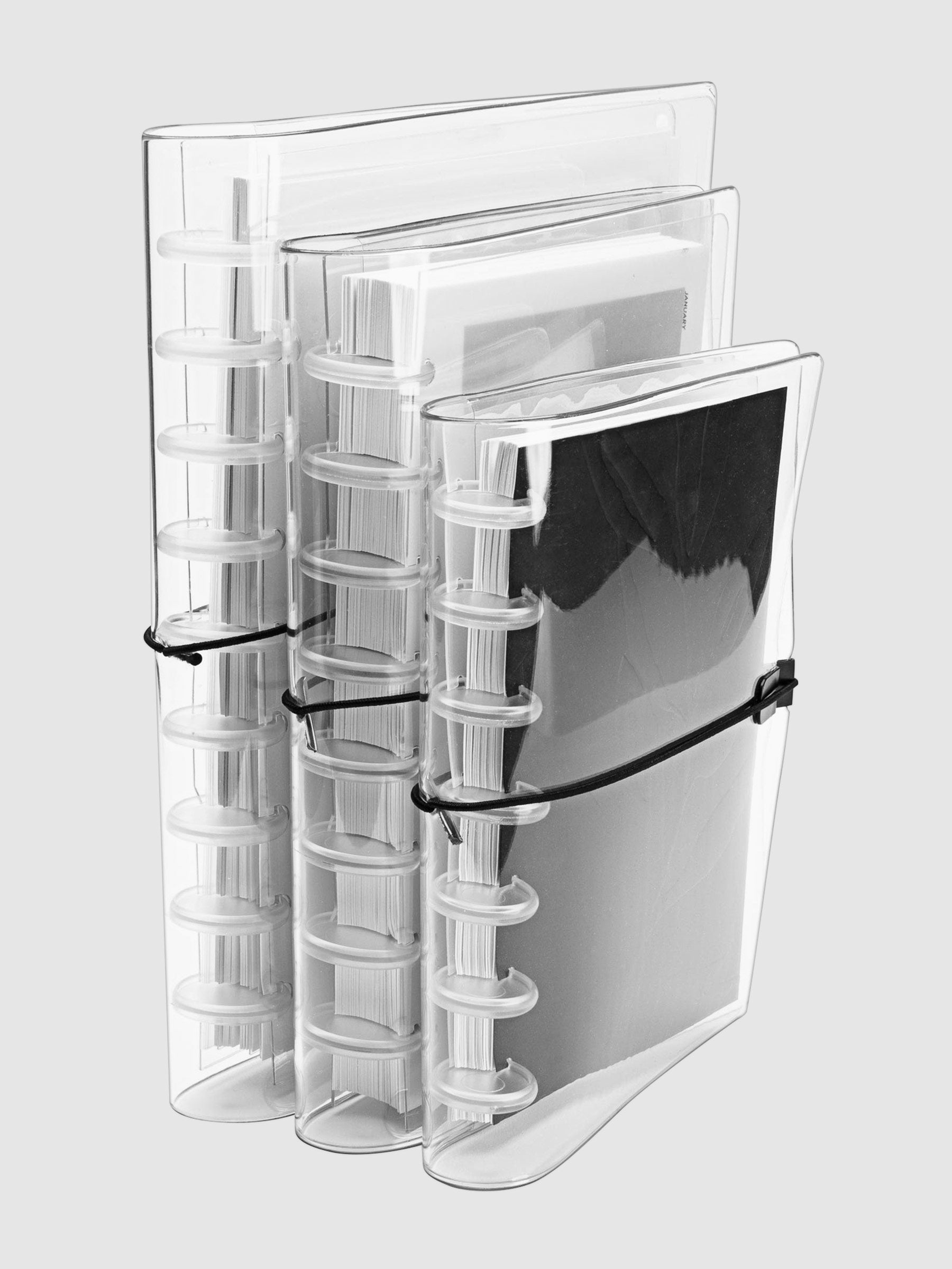 Small, Large, and HP Classic covers arranged in a row on a neutral background. Each cover is filled with a discbound planner system in respective sizing.