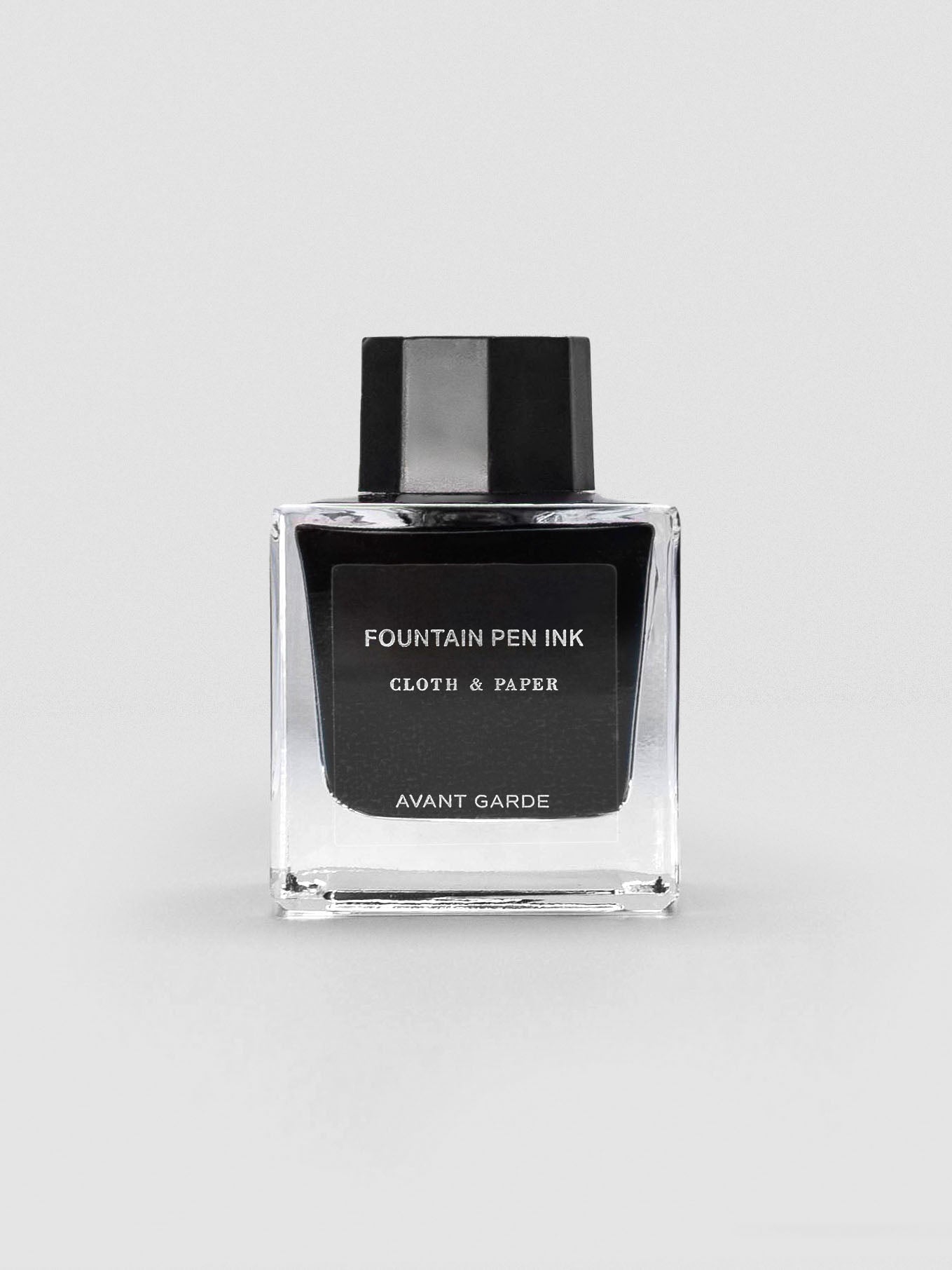 A square glass bottle of Cloth & Paper Fountain Pen Ink in Avant Garde, sealed with a black cap.