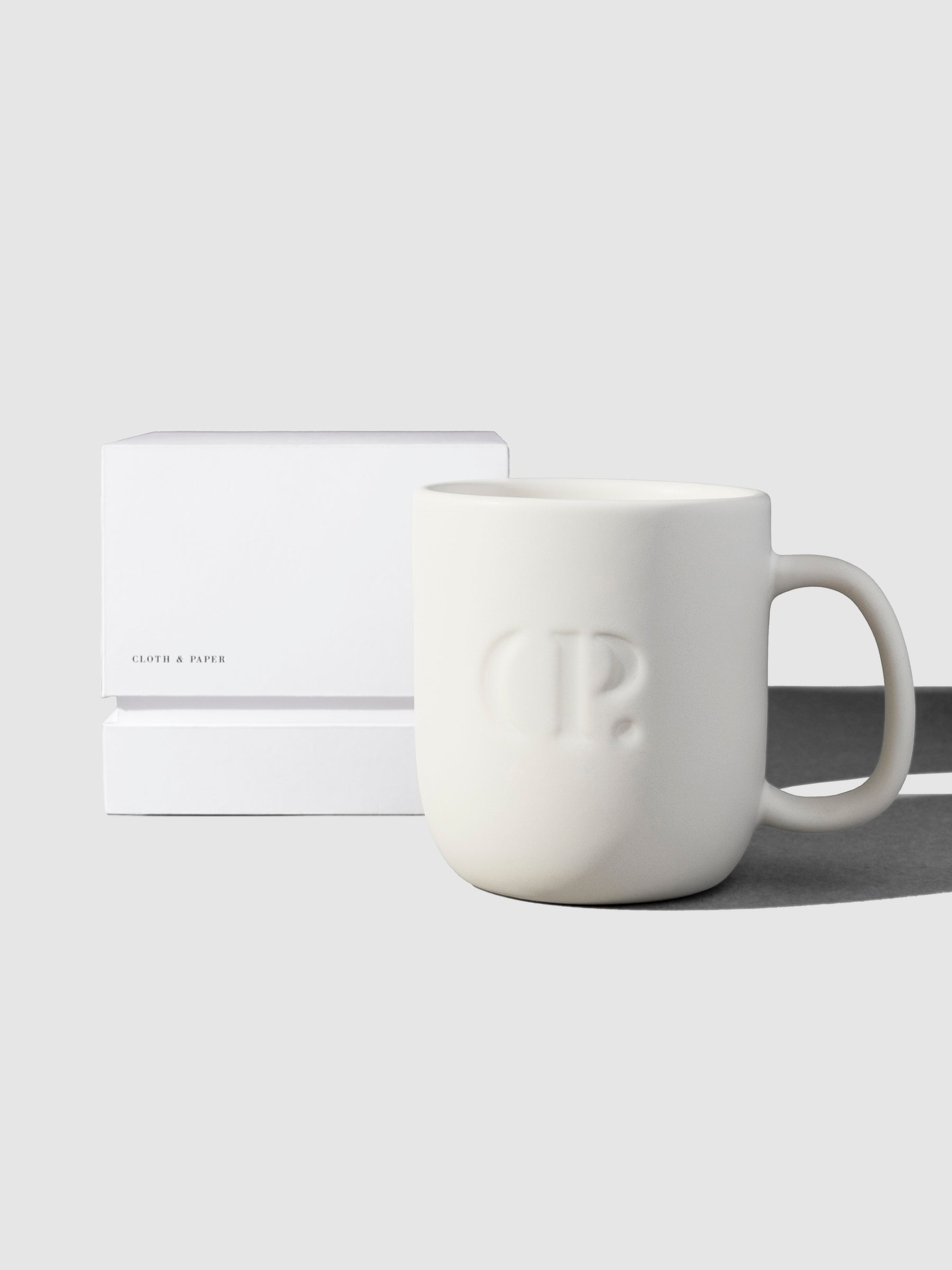 Mug shown with its packaging on a neutral background.
