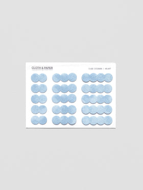 A sticker sheet of cloud-shaped, blue, velvet stickers shown in three sizes for a total of 15 stickers.