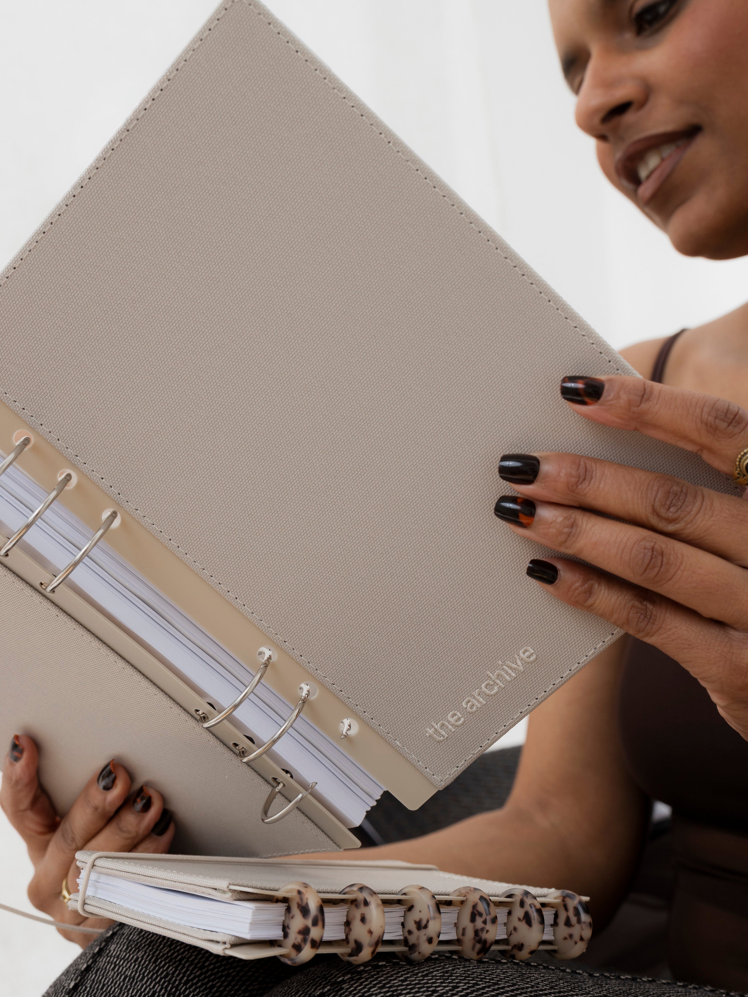 Woman holding the Archive Bookcloth Planner Cover in size A5.