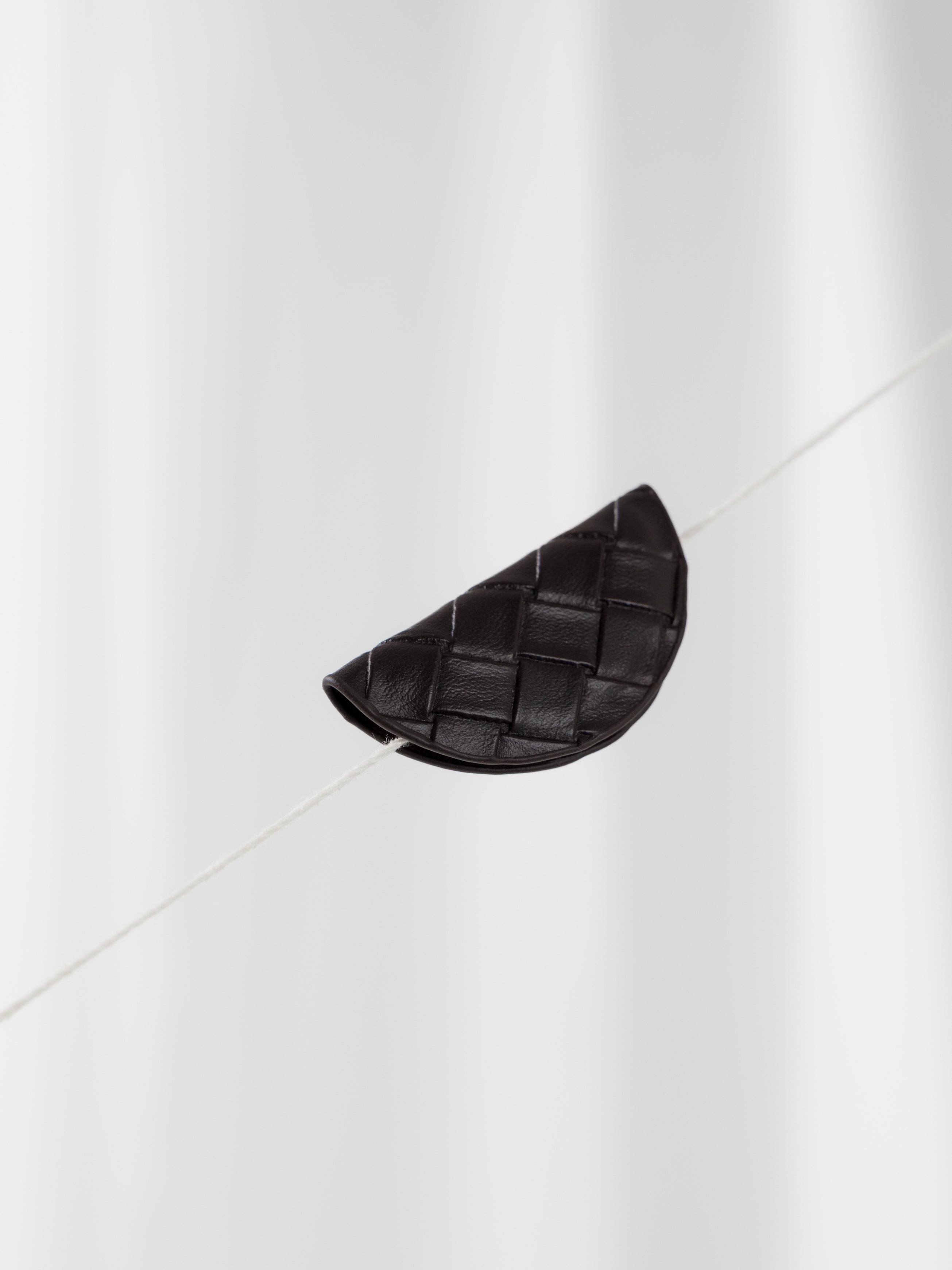 Woven magnetic bookmark in the color walnut brown against a light background.