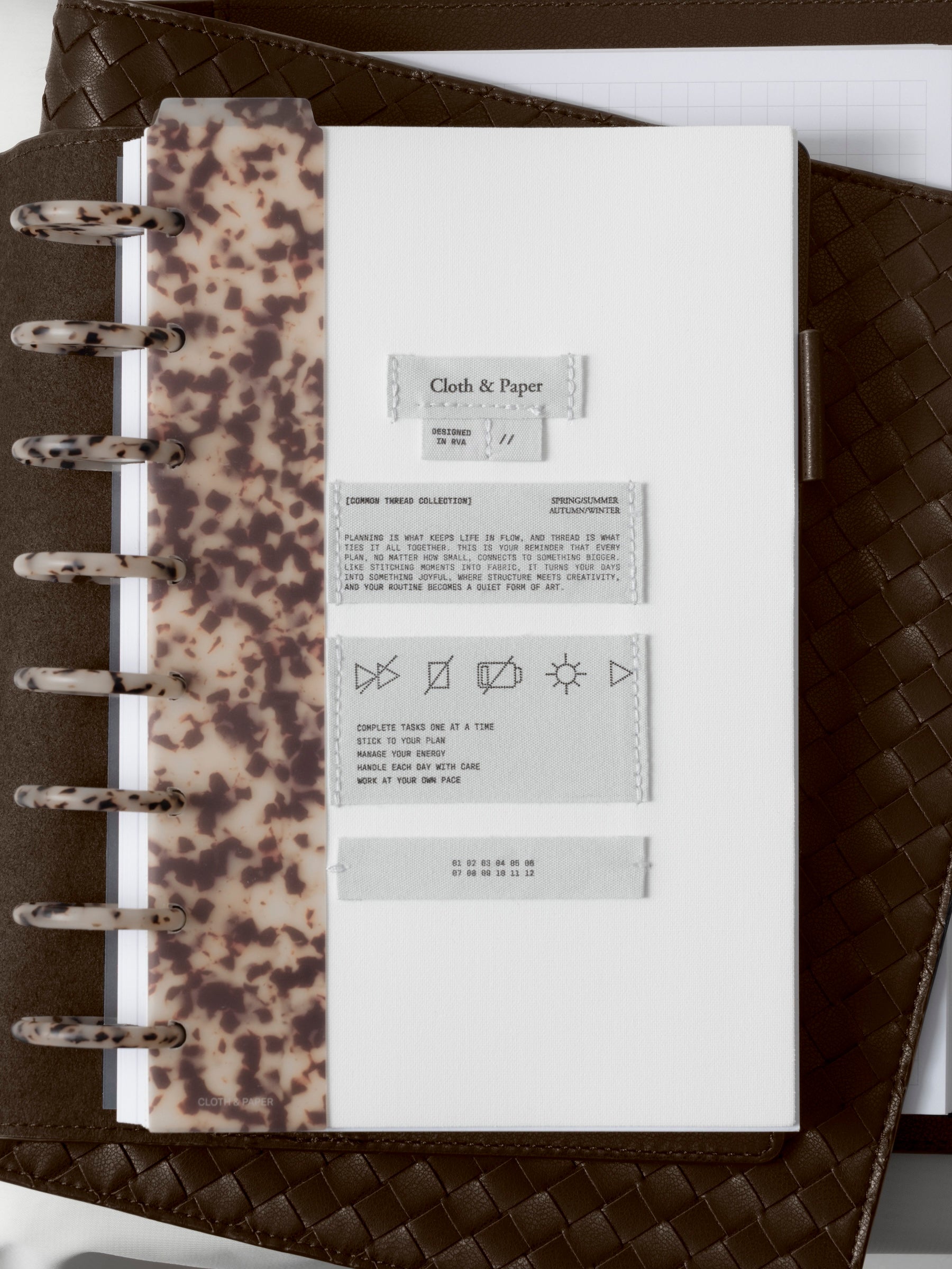 Close up of the Sewn Tags Planner Dashboard in a discbound planner.