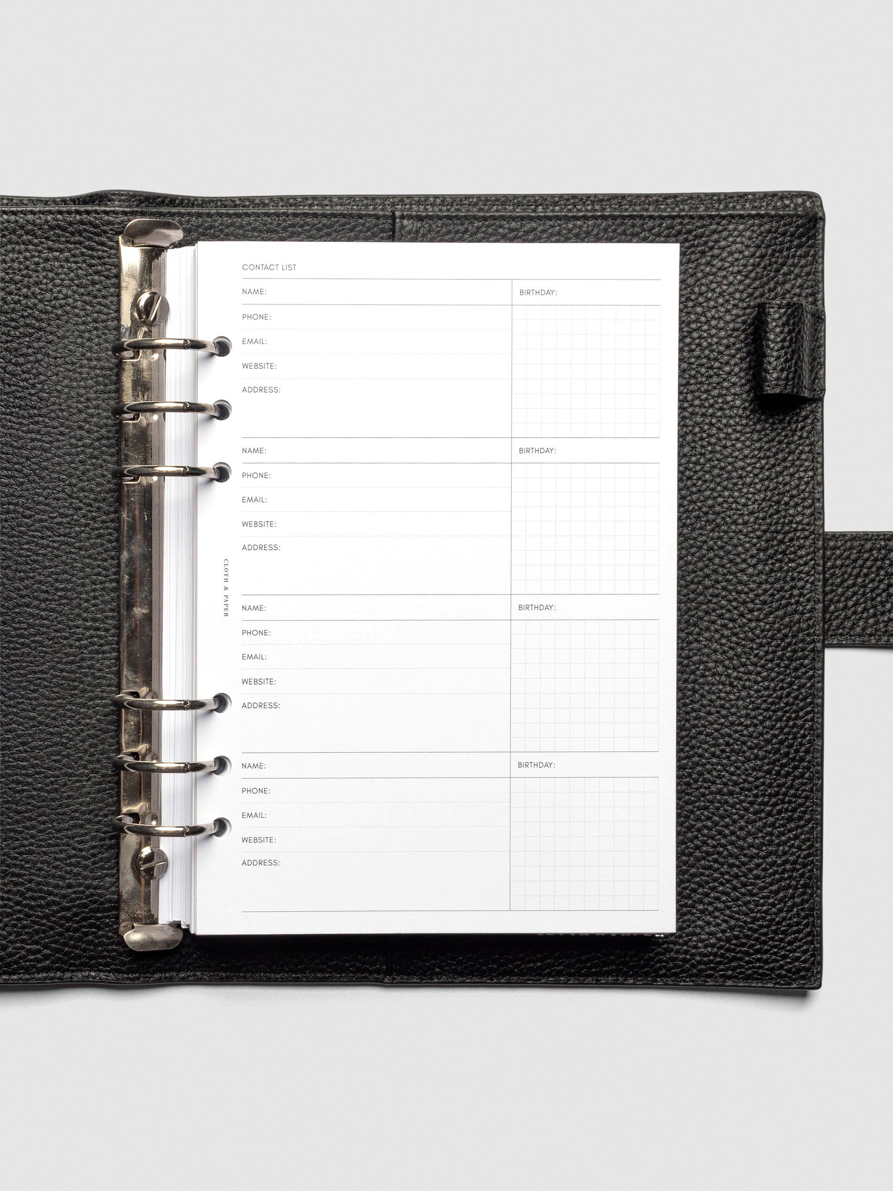 Refreshed Contact List Planner Inserts styled inside a black leather agenda. 
