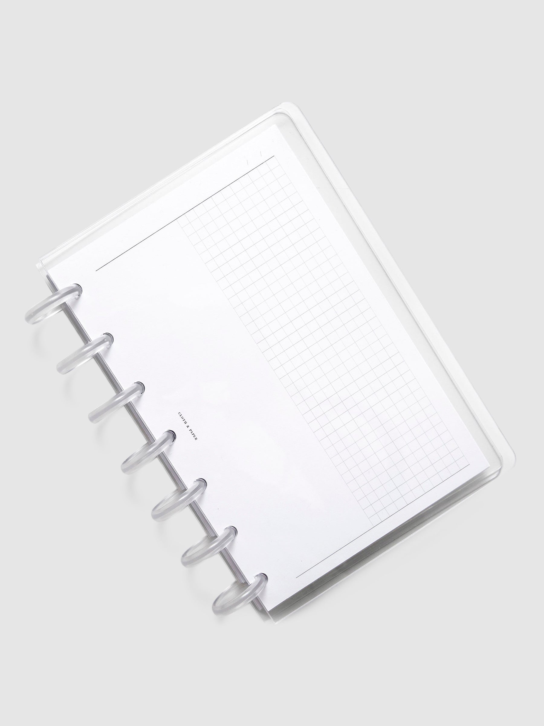 Crystal Clear Discbound Notebook Cover, HP Mini, Cloth and Paper. Notebook covers in use with clear rings and an insert.