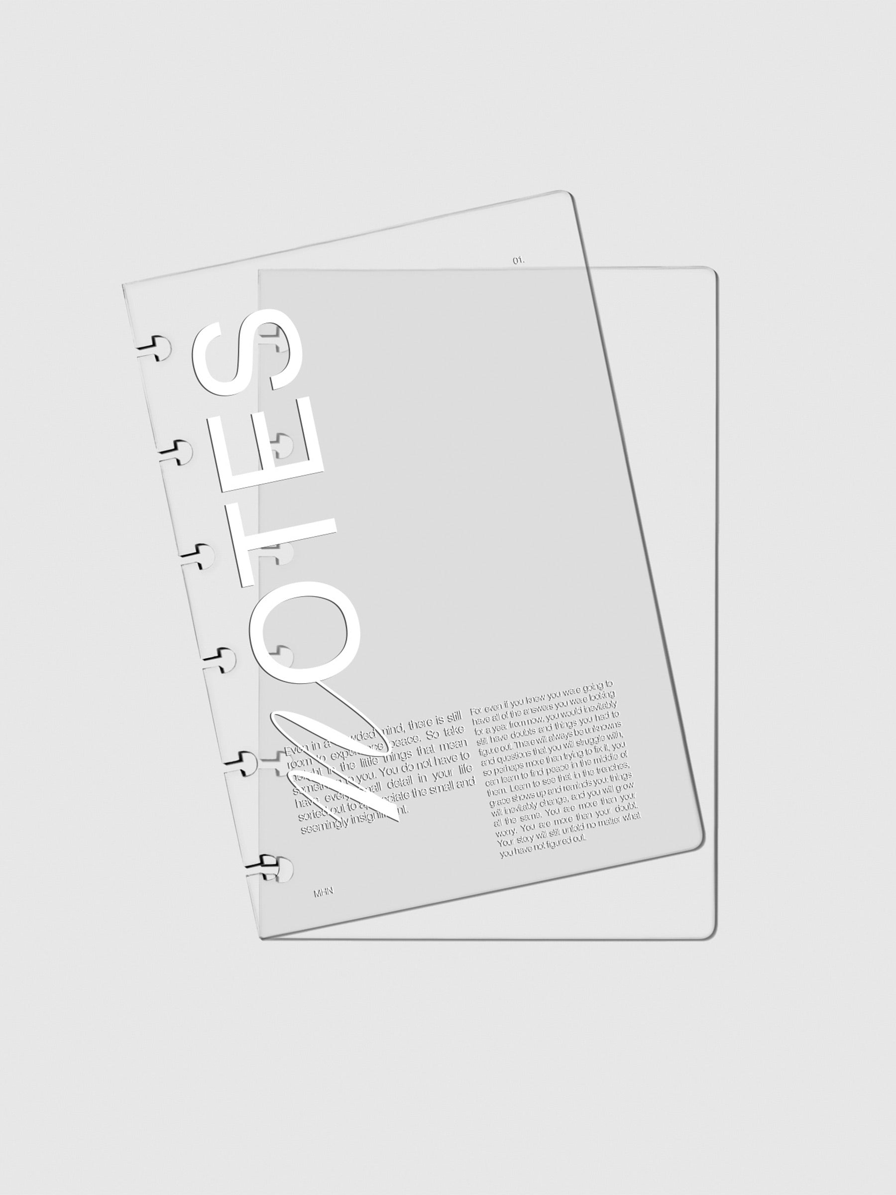 Two Crystal Clear Discbound Notebook Covers Notes laid on top of one another with the top cover tilted slightly to the left.