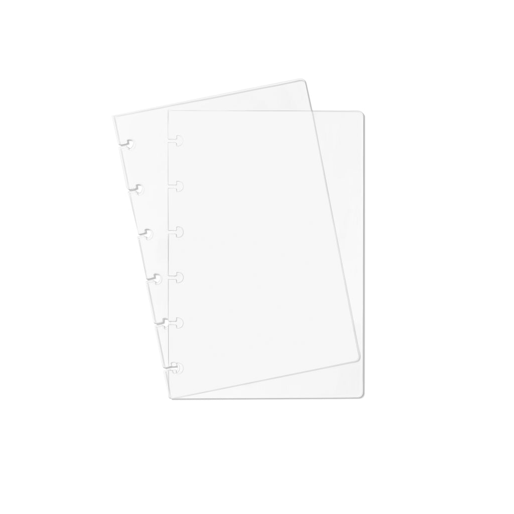 Two transparent notebook covers laid on top of one another with the top cover tilted slightly to the left.