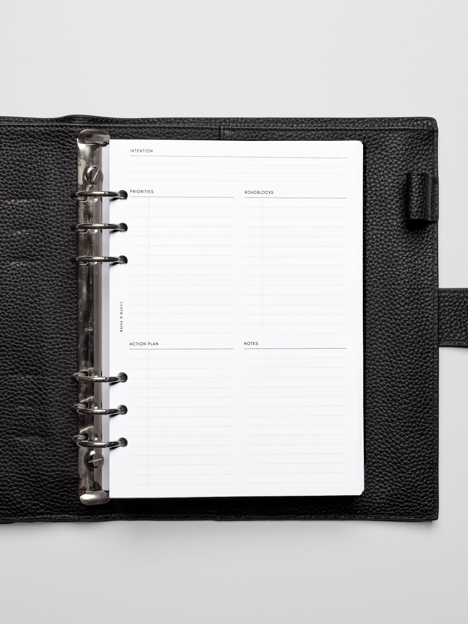 Daily Intention Planner Inserts in A5 size shown in a leather agenda.