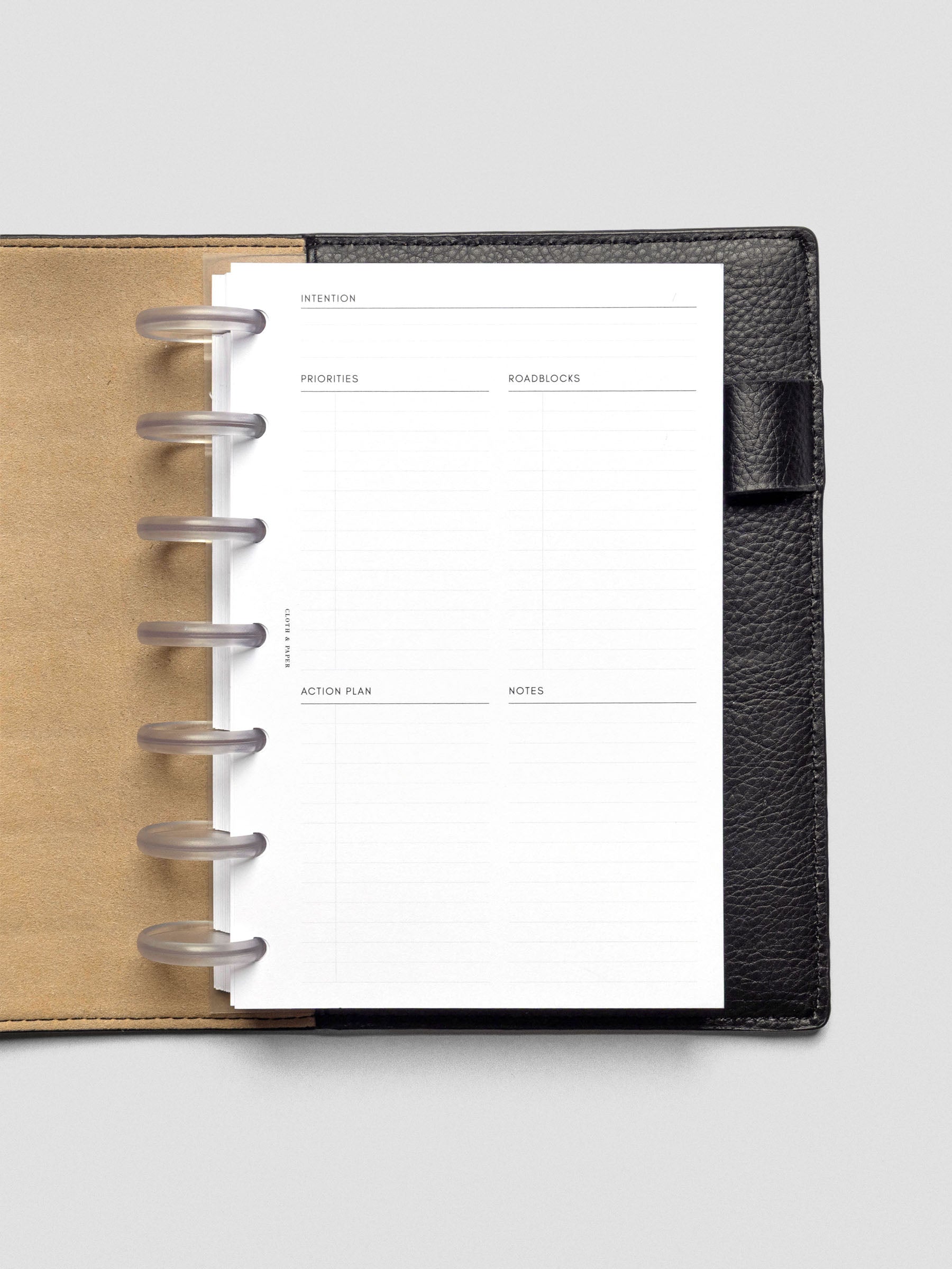 Daily Intention Planner Inserts show blank in Half Letter size disc bound in a leather cover.