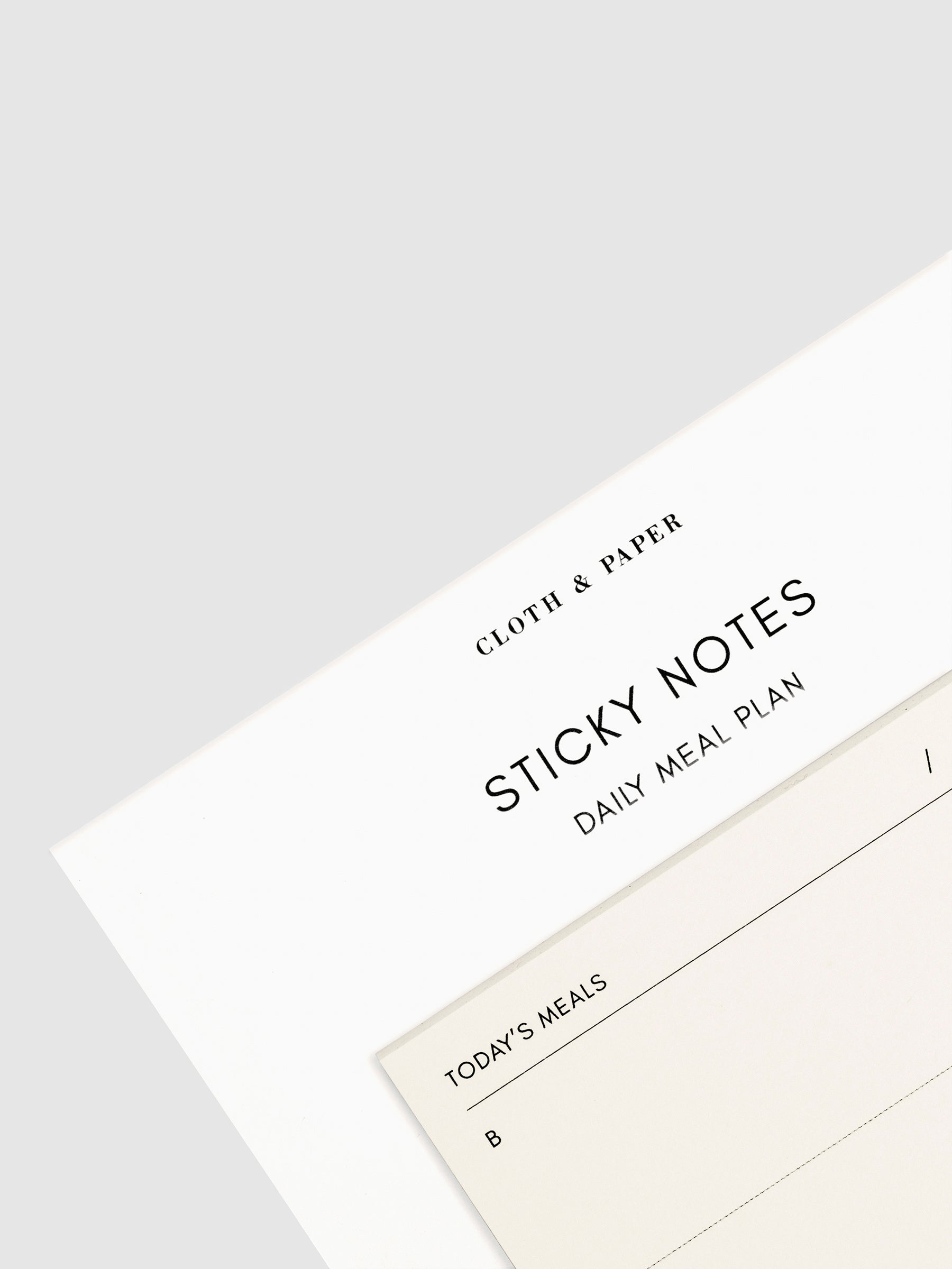 Close-up of a Daily Meal Plan Sticky Notes on their backing, against a neutral background.