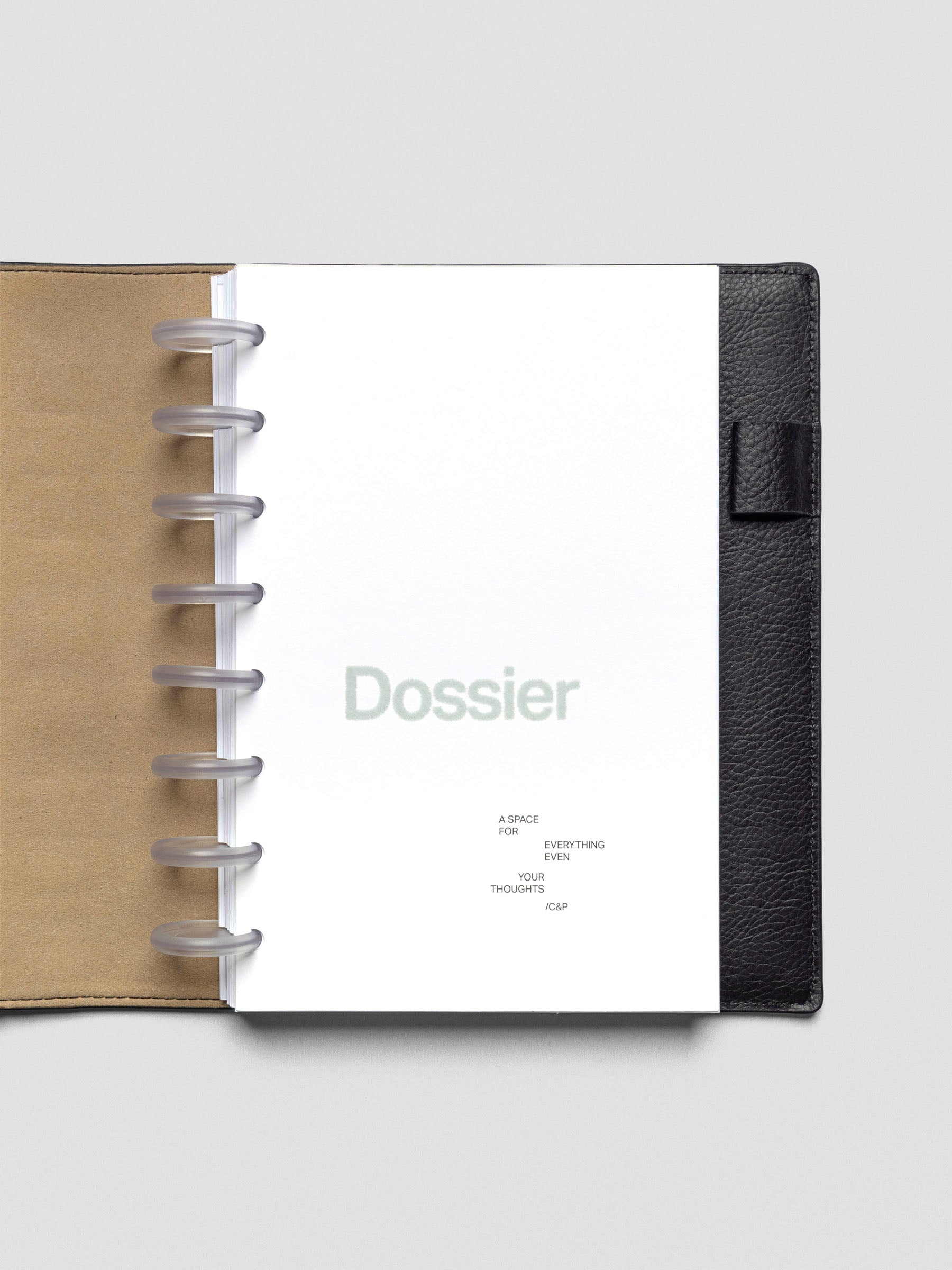 Dossier Planner Dashboard in Half Letter size shown disc bound in a leather planner cover.