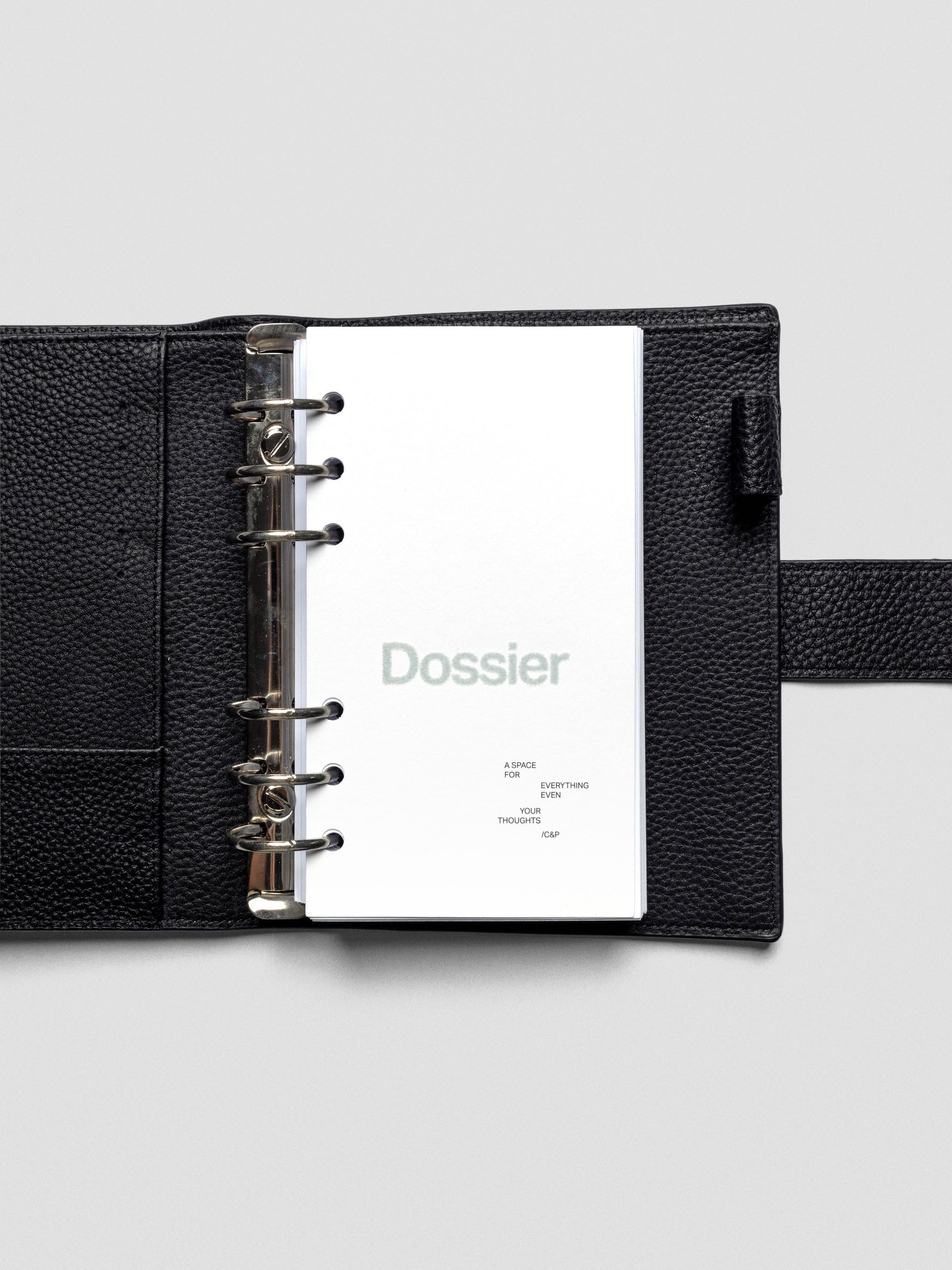 Dossier Planner Dashboard in Personal size shown ring bound in a leather planner cover.