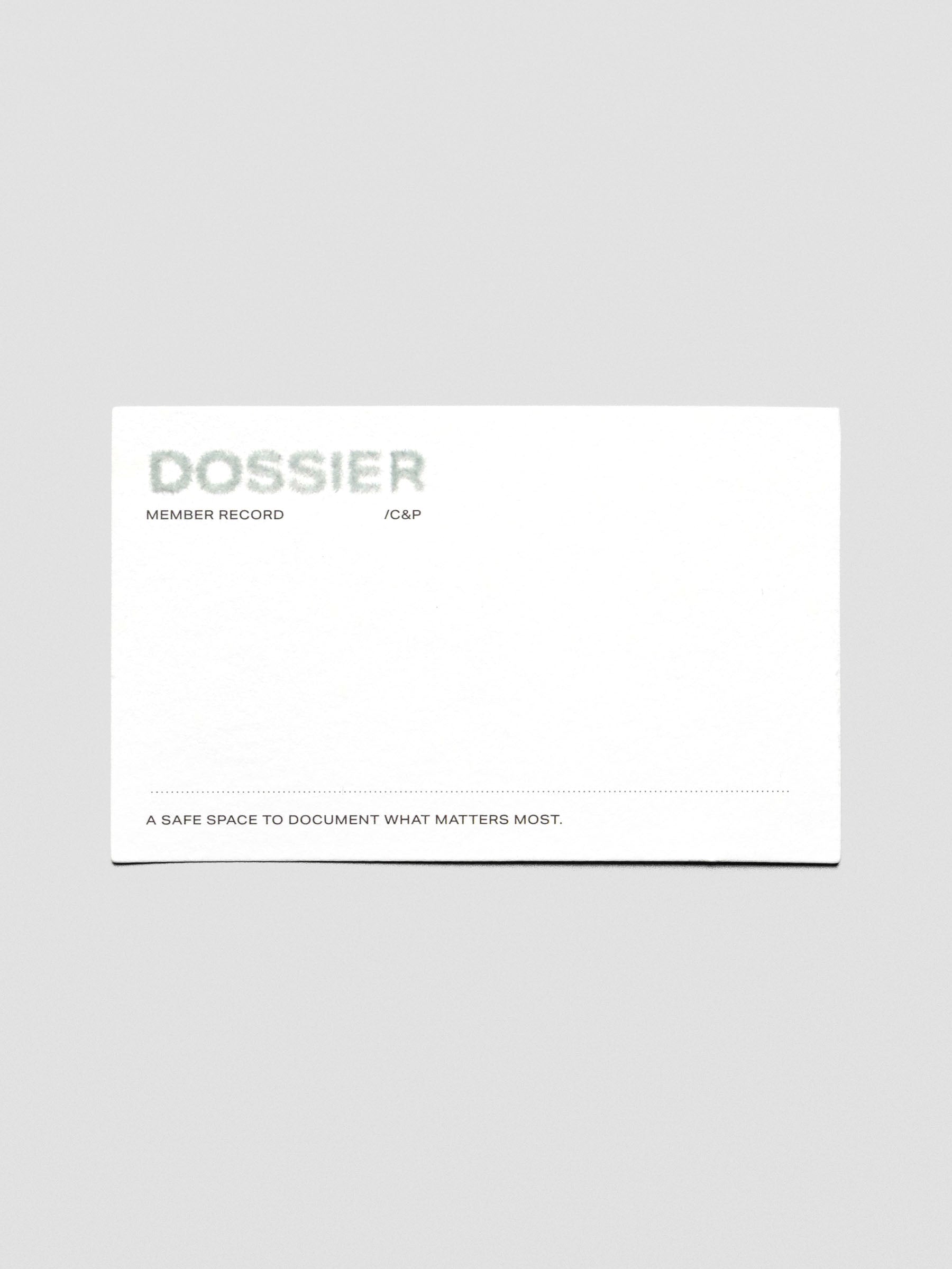 Dossier Journaling Card on white cardstock with flocked text reading "Dossier" in a blue-green color.