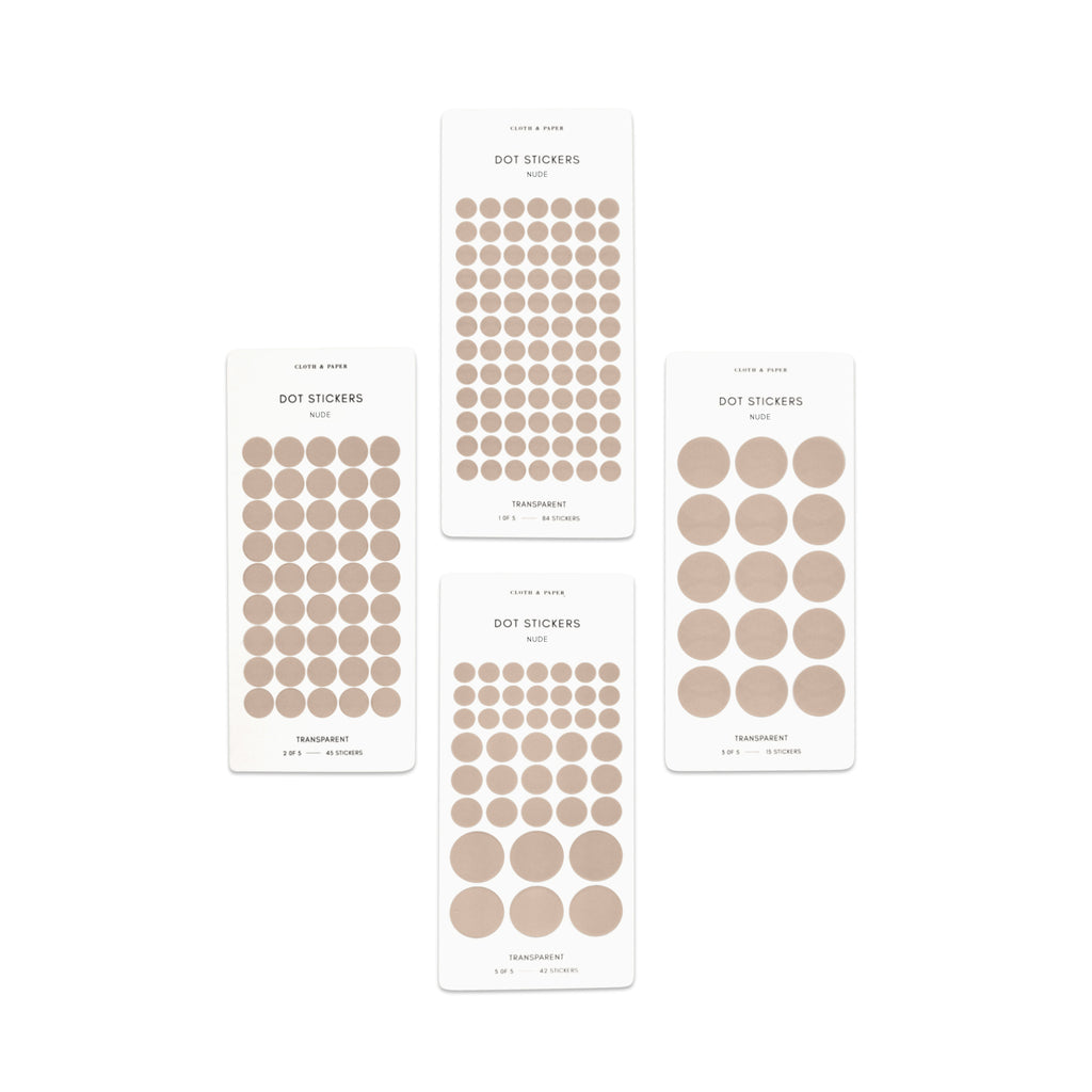 Four sheets of Nude dot stickers with varying sizes placed parallel to each other on a white background.