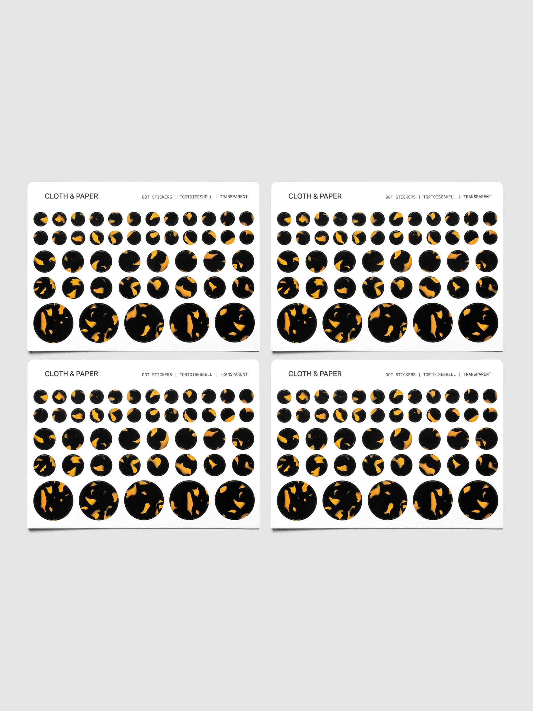 Tortoiseshell stickers displayed on a neutral background. Four sheets are placed next to each other showing small, medium, large, and mixed sticker sizes per sheet.