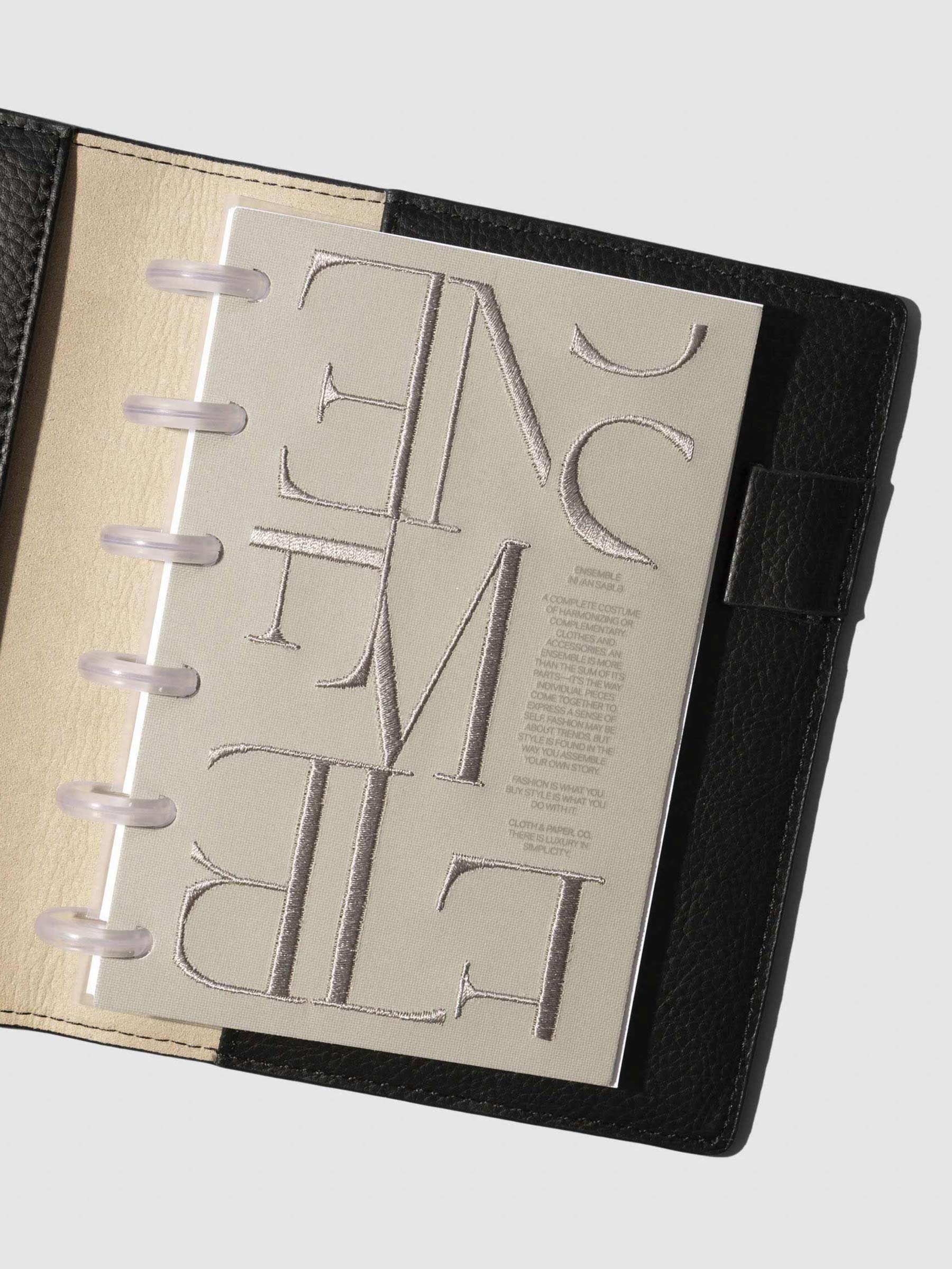 Dashboard displayed in a black planner on a neutral background. Size shown is CP Petite.