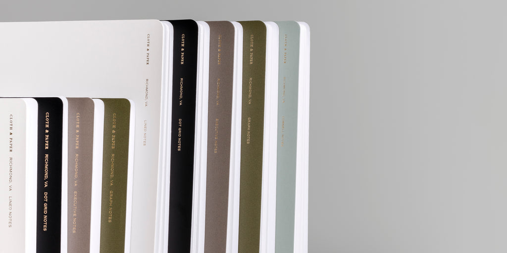 an image representing the different colors and styles available for our España Spiral Notebooks.  In order are Ash, Avant Garde, Cafe Noir, Olive, and Mykonos. 
