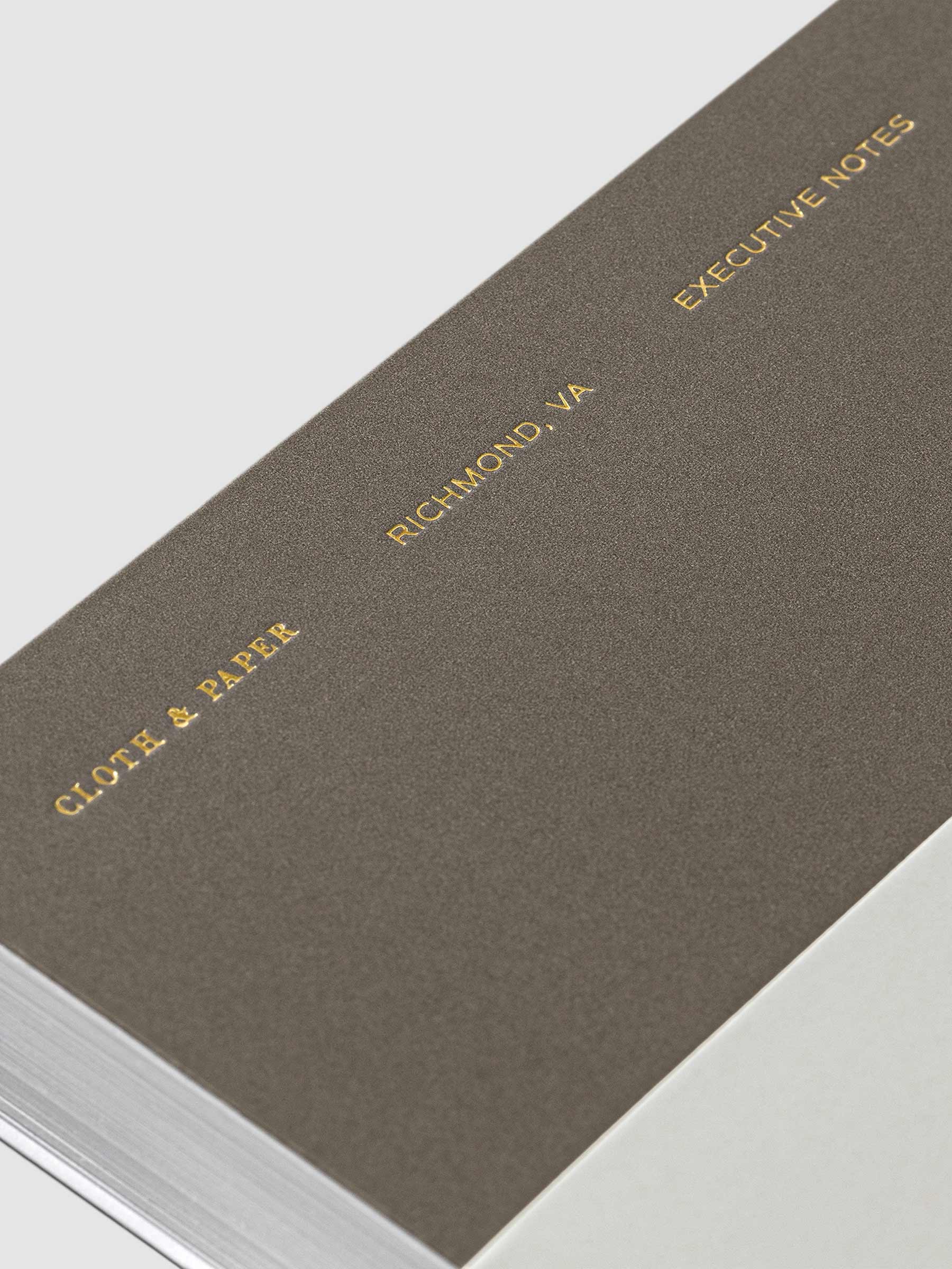 Closeup of text on Cafe Noir notebook. From bottom to top it reads - "Cloth & Paper / Richmond, VA / Executive Notes"