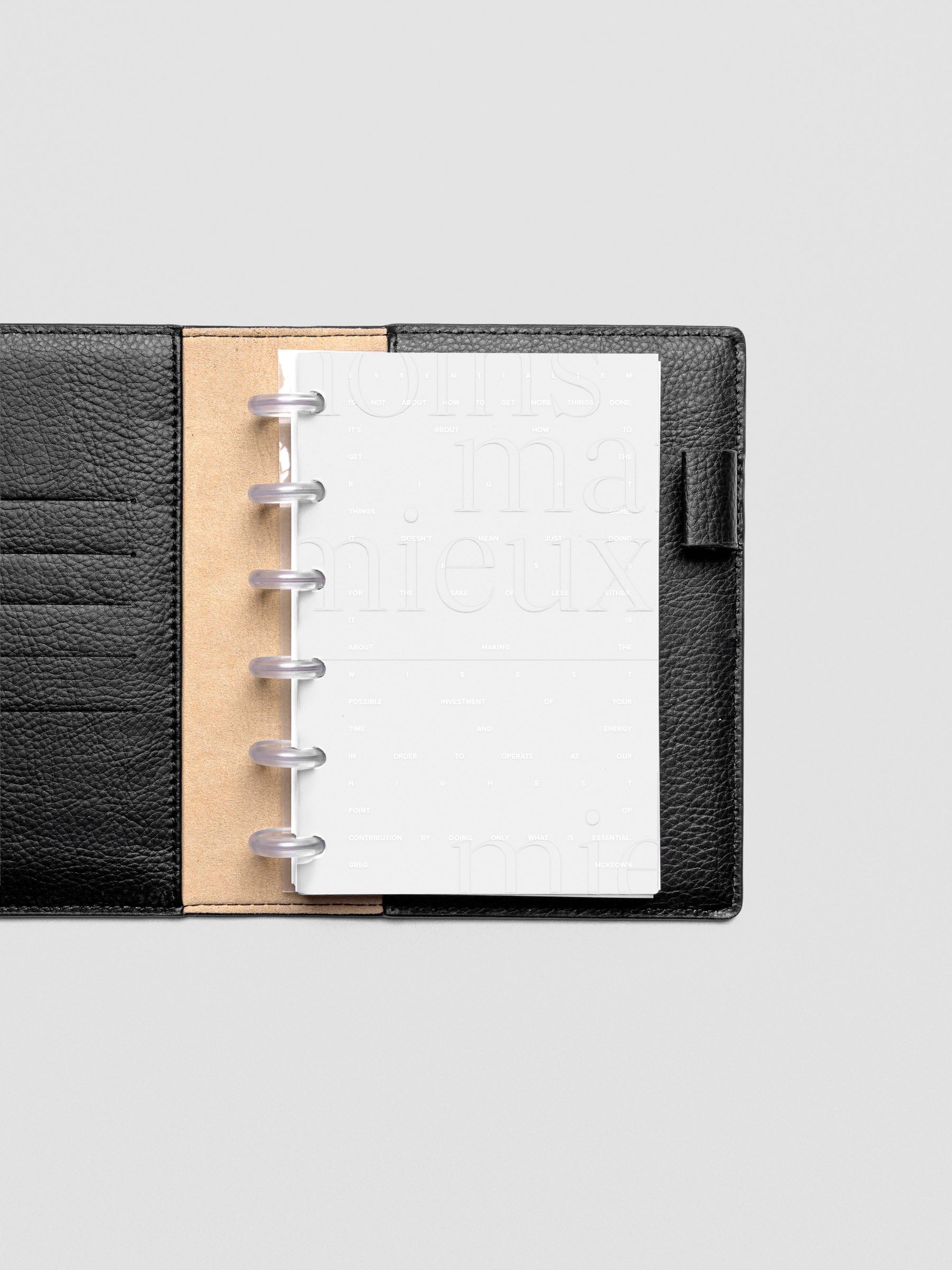 Essentialism Dashboard Duo reading "moins mai mieux" in size CP Petite; shown discbound in leather folio.