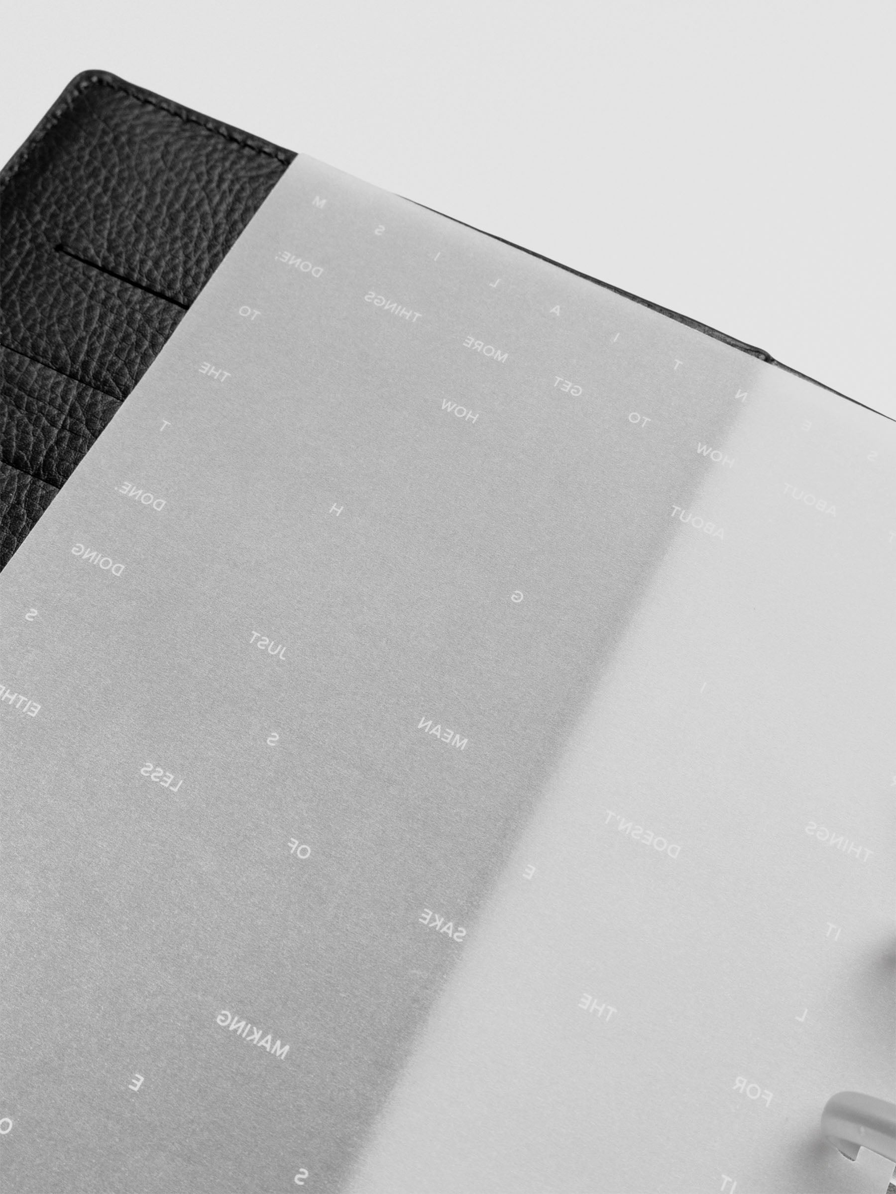 Essentialism Dashboard Duo reading "moins mai mieux" in size Half Letter; close up.