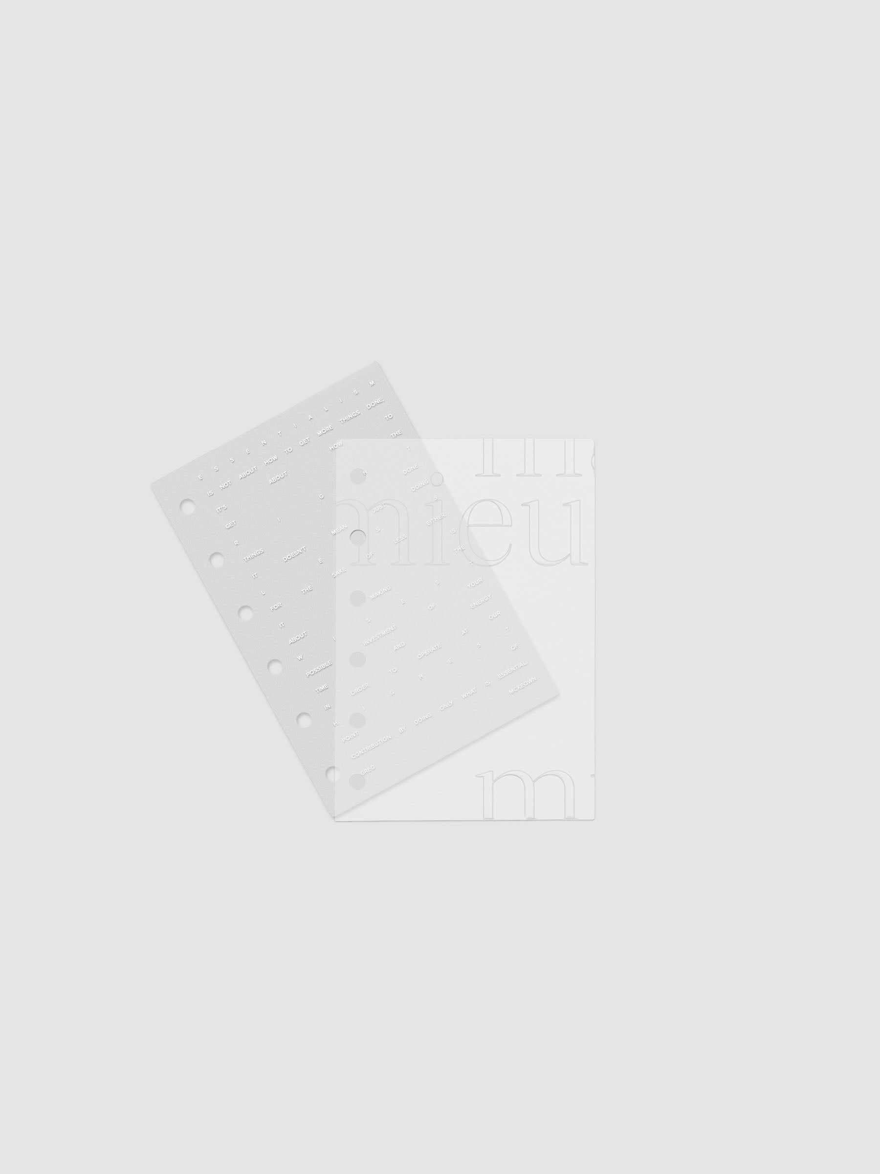 Essentialism Dashboard Duo reading "moins mai mieux" in size Pocket shown with layers offset.