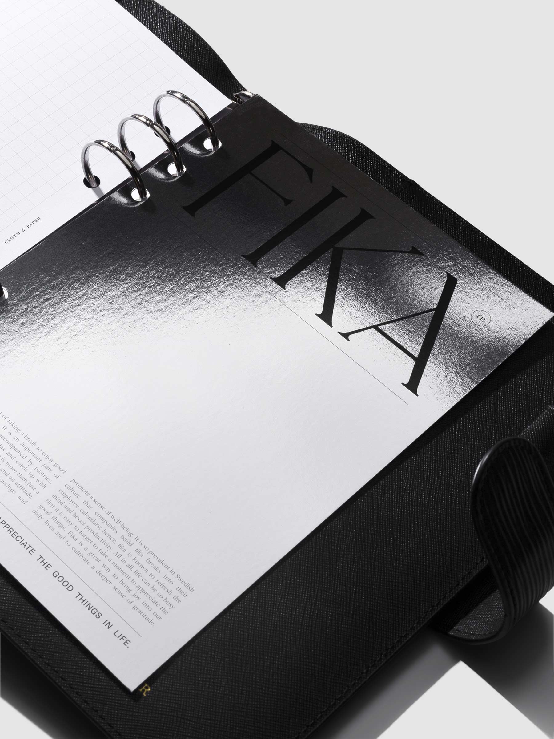 Dashboard in use inside a black leather agenda. Photo is angled in a way to show the dasboard's holographic reflective material.