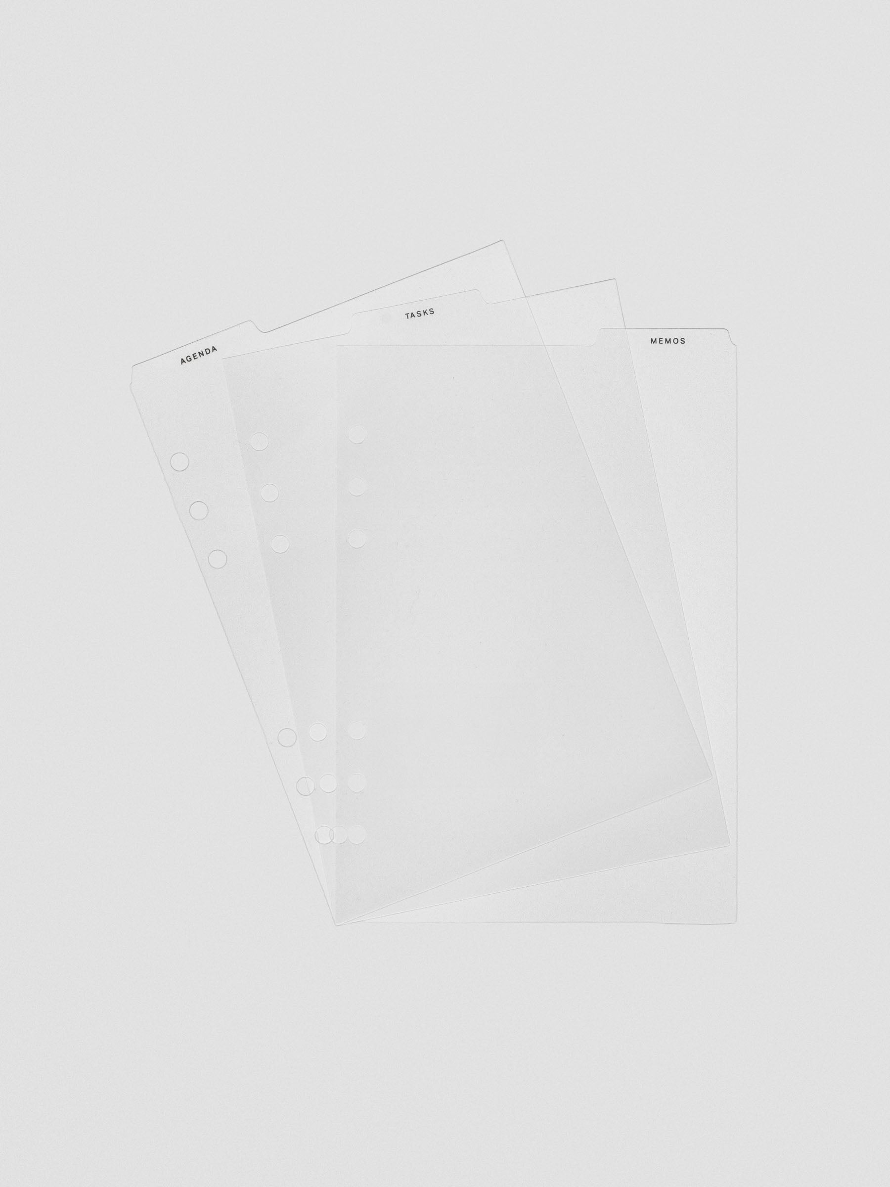 Set of three ultra-thin clear planner dividers fanned out, each with a top tab labeled Agenda, Tasks, or Memos.