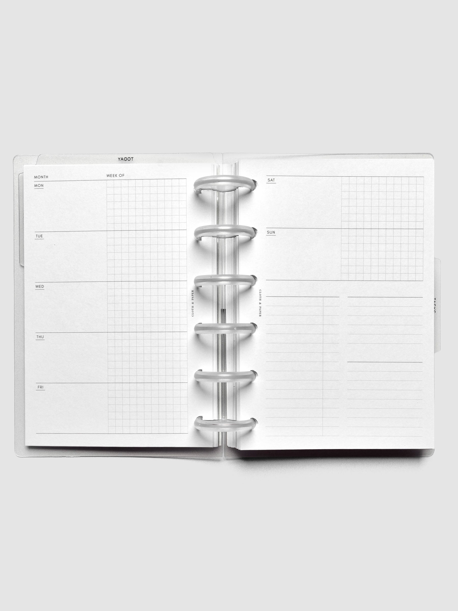 Open discbound planner showing an undated weekly scheduling layout with space for to-do lists and notes.