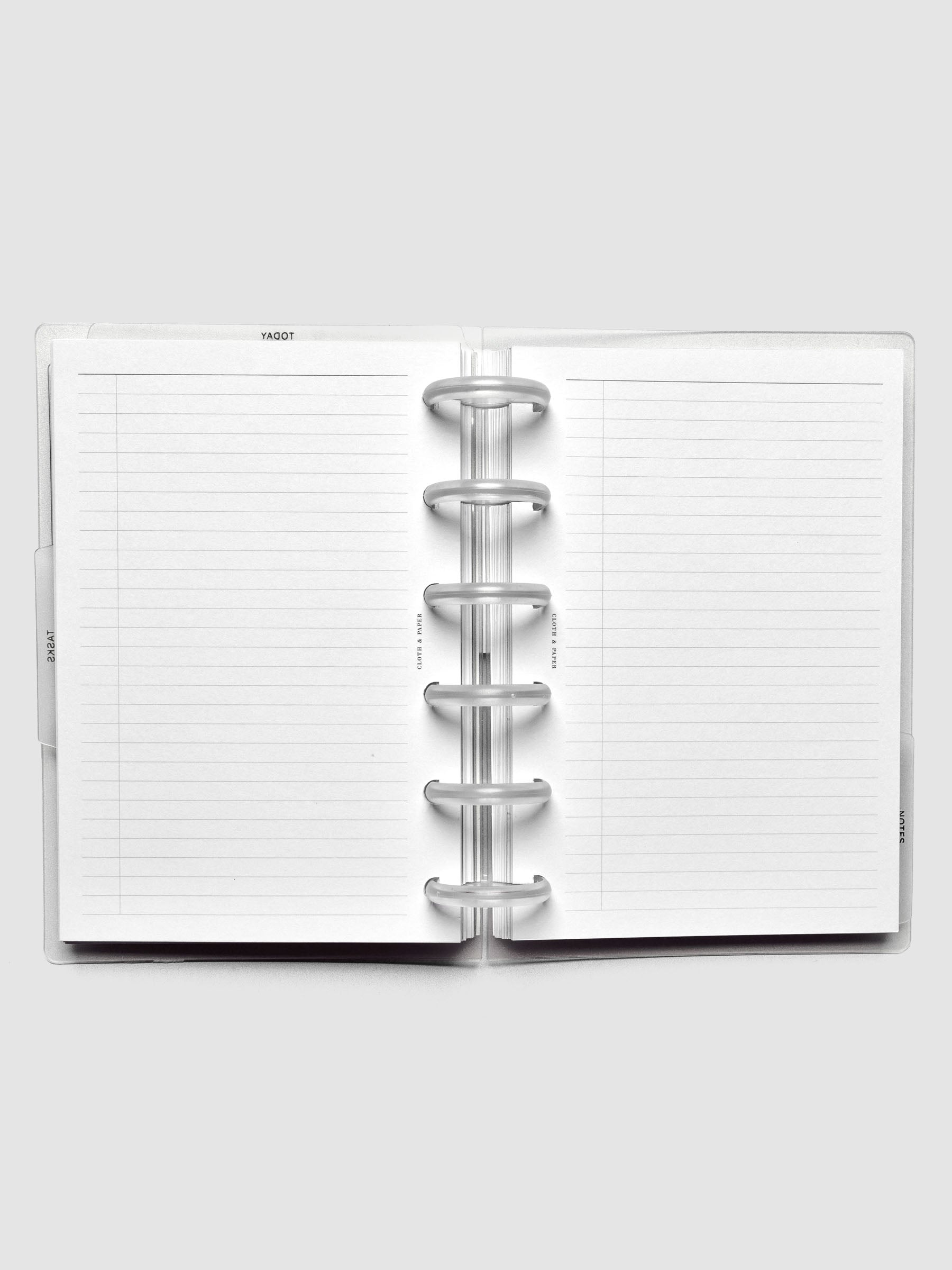 Open discbound planner showing task planner inserts.