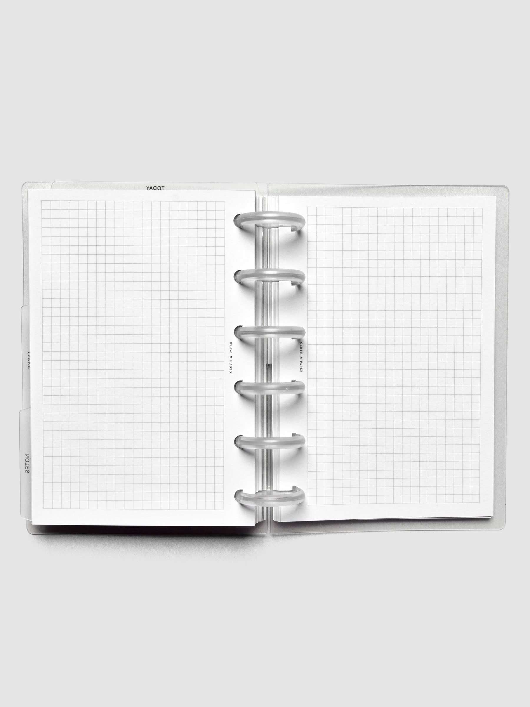 Open discbound planner displaying graph note planner inserts.