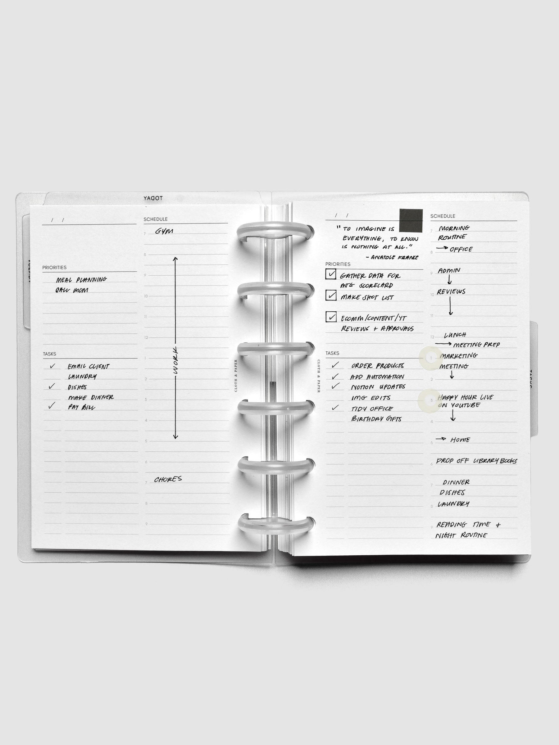 Open 6-disc planner displaying daily schedule inserts with handwritten notes and stickers.