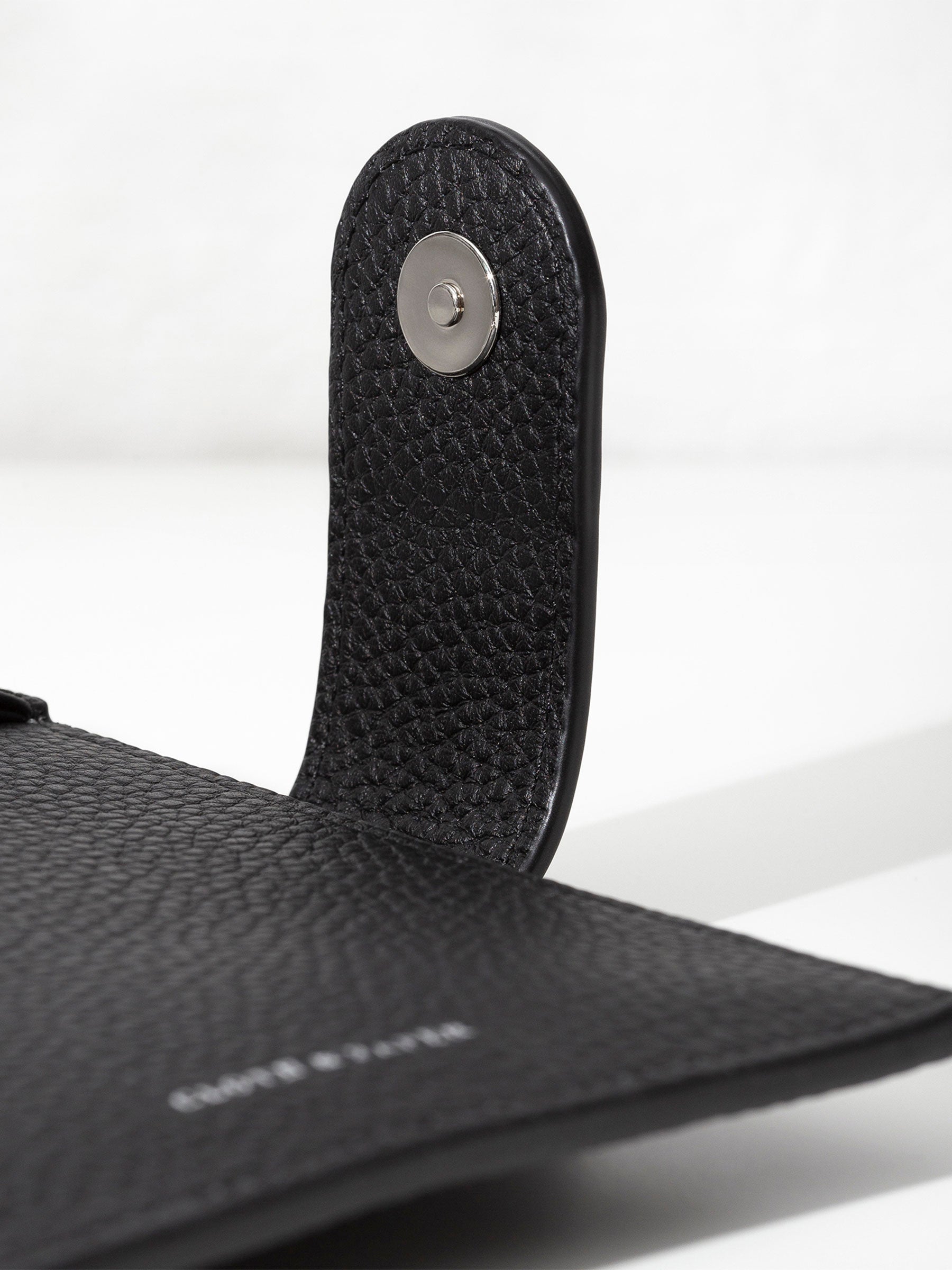 Closeup of silver snap hardware.