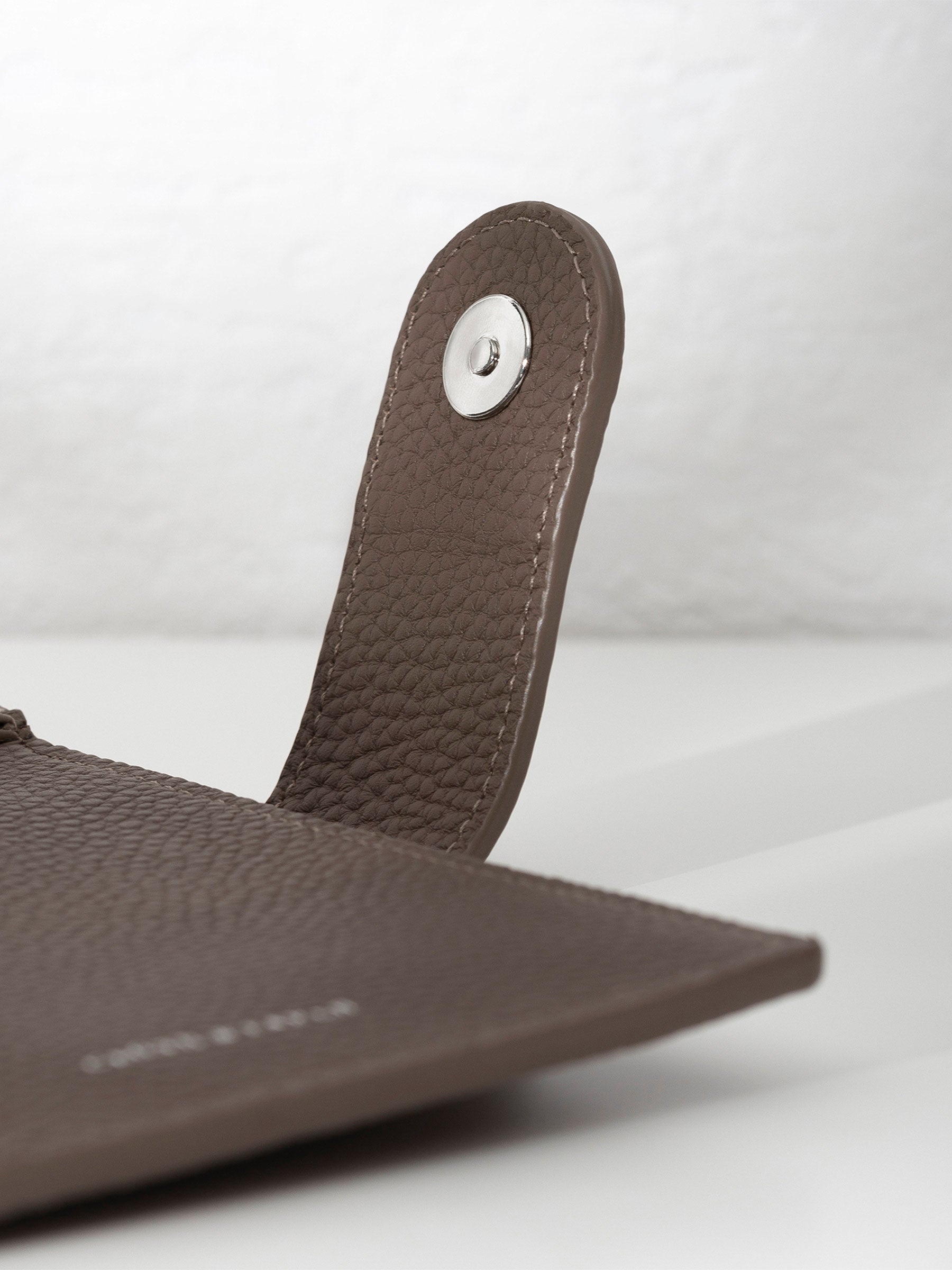 Closeup of silver snap hardware.