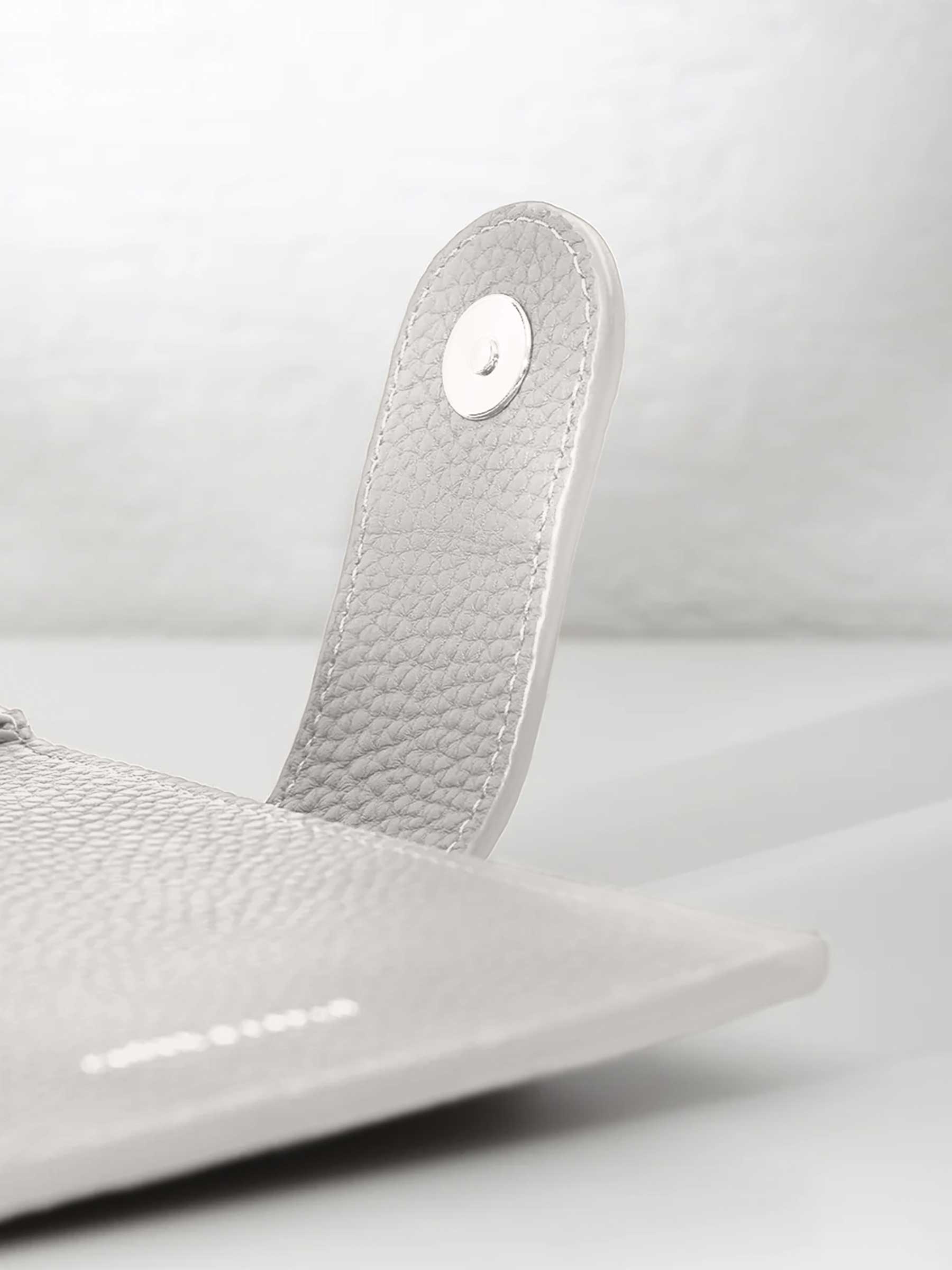 Closeup of silver snap hardware.