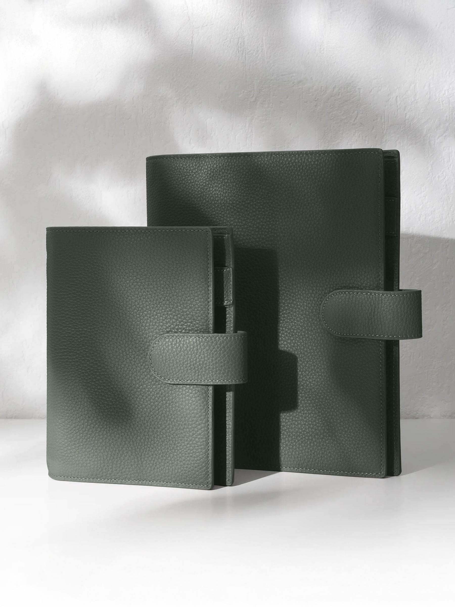 Two Cypress leather agendas displayed against a shadowed background.