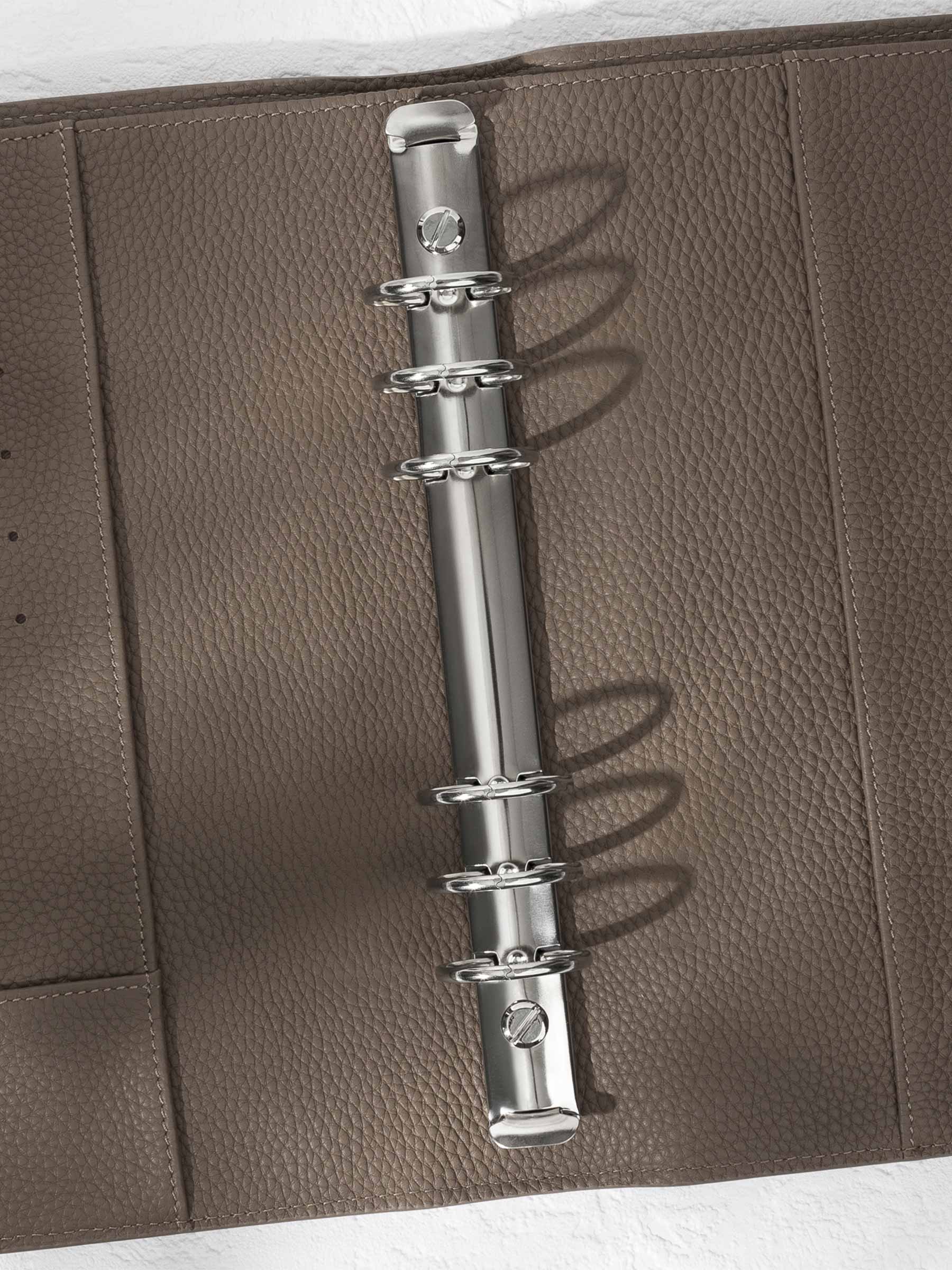 Closeup of silver hardware in a cortado leather agenda.