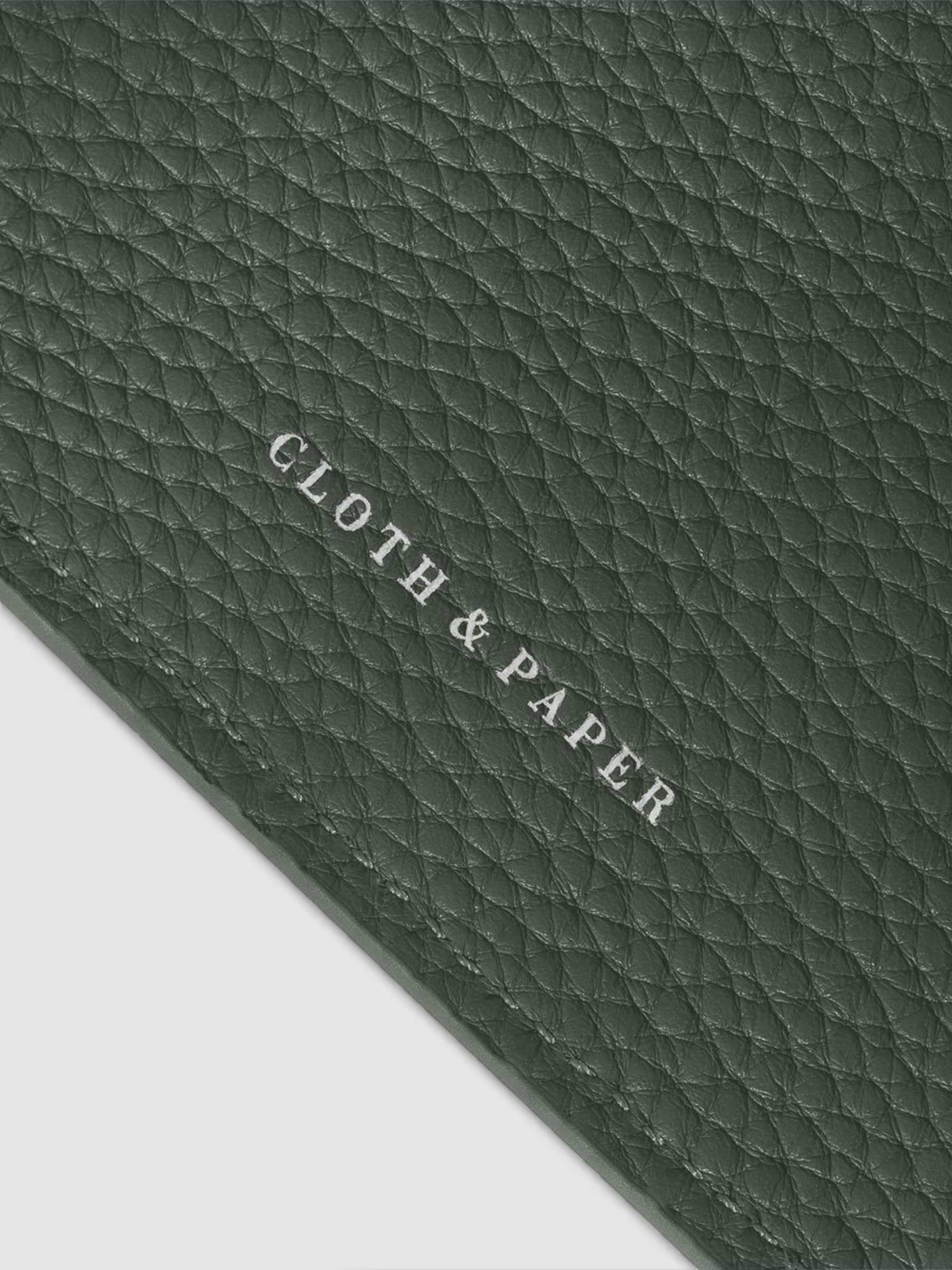Close-up of the silver Cloth & Paper logo on the Cypress leather agenda
