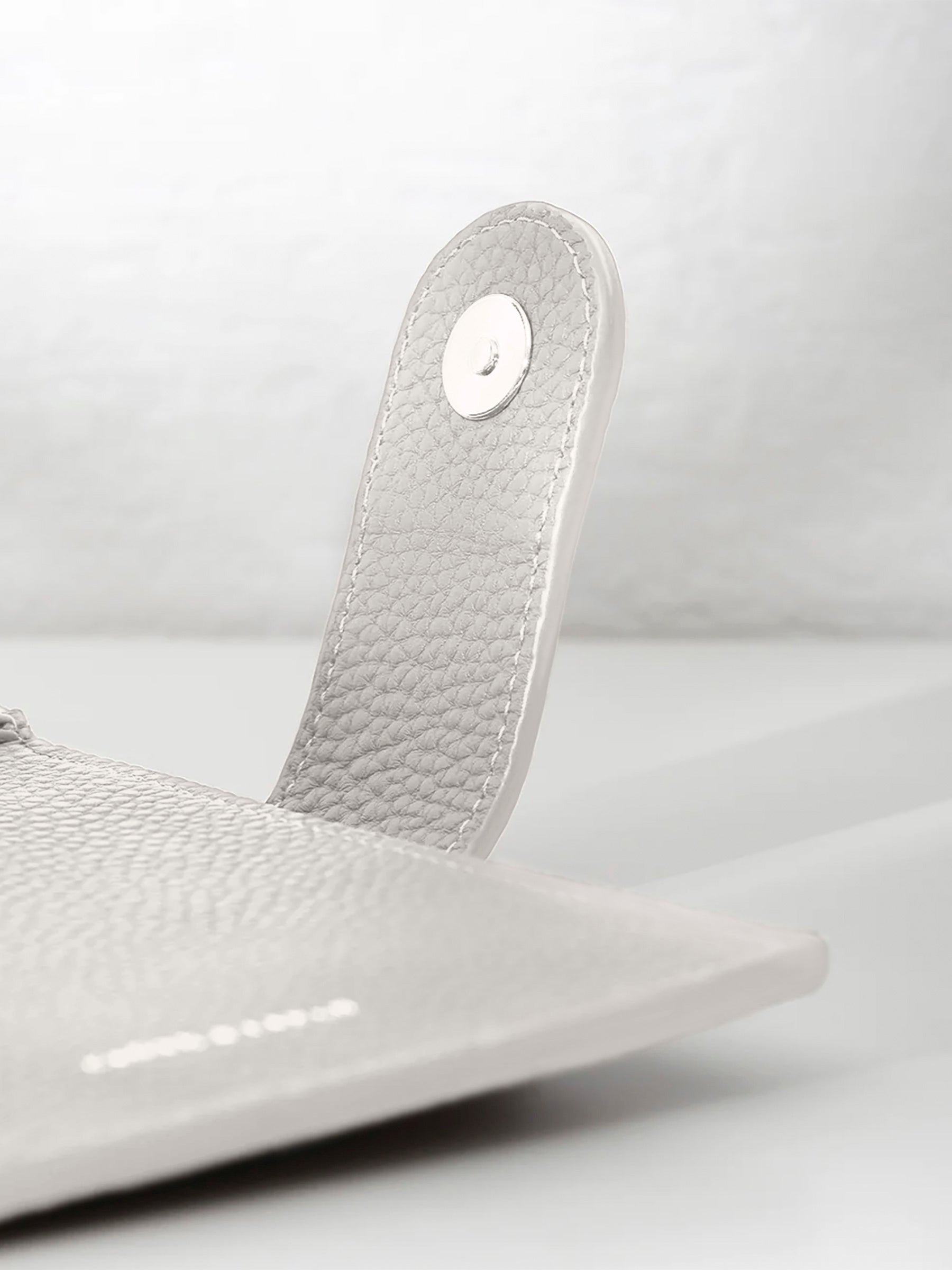 Closeup of silver snap hardware.