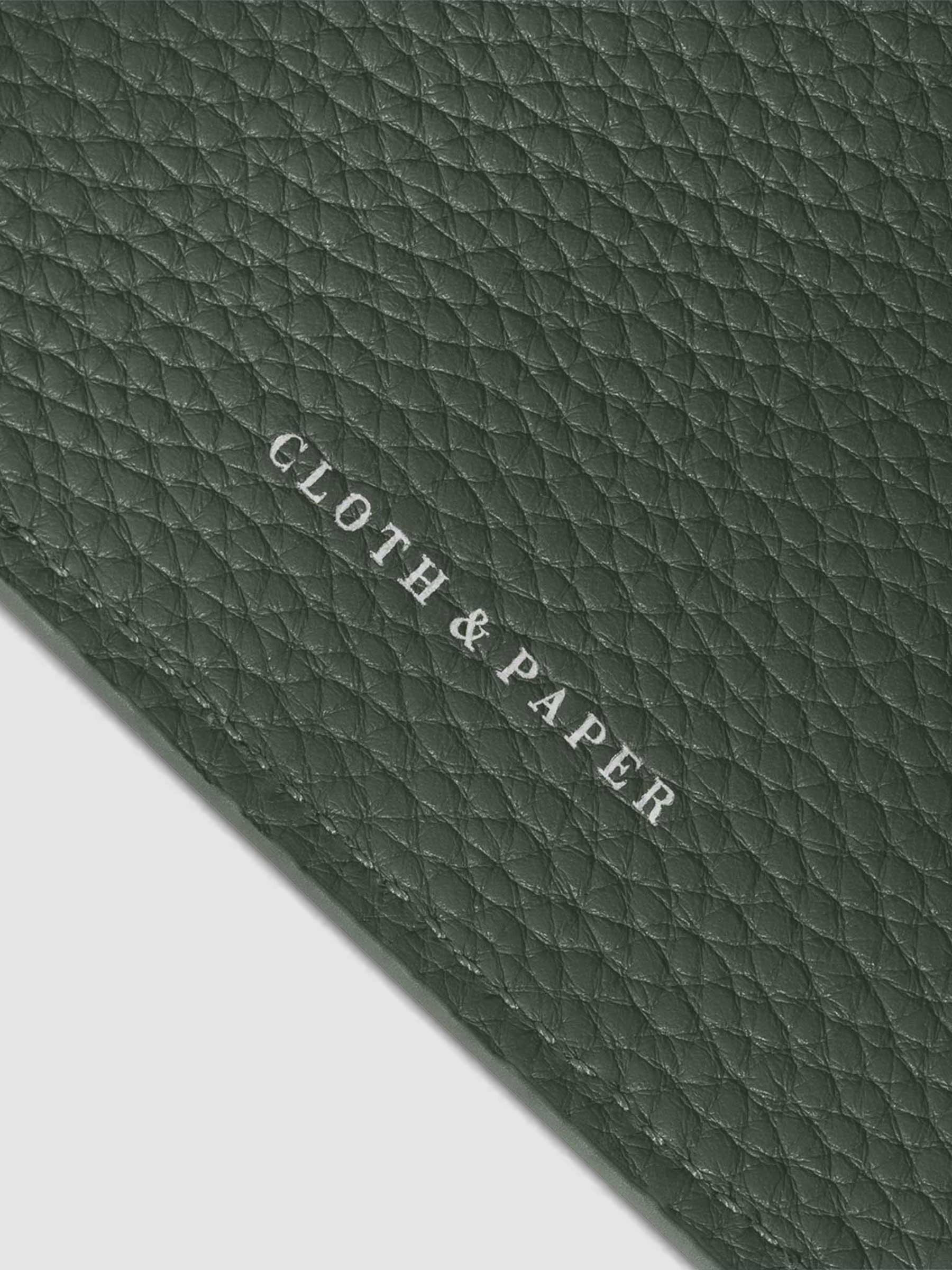 Close-up of the silver Cloth & Paper logo on the Cypress leather agenda.