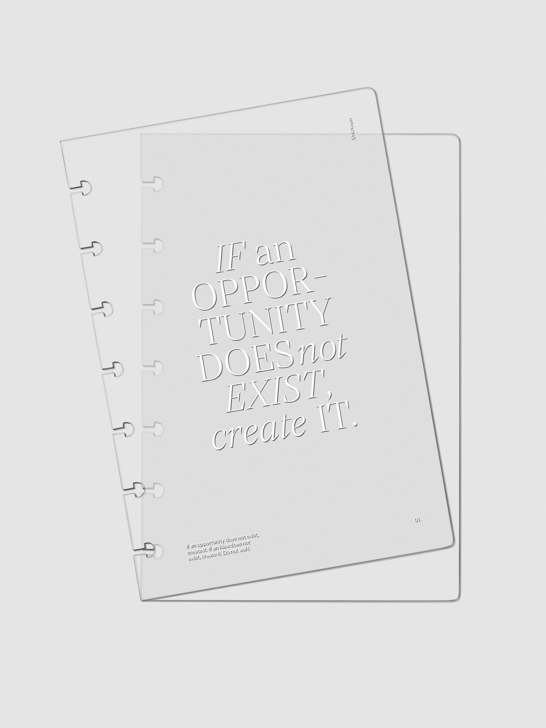 Two Crystal Clear Discbound Notebook Covers "Opportunity" laid on top of one another with the top cover tilted slightly to the left.