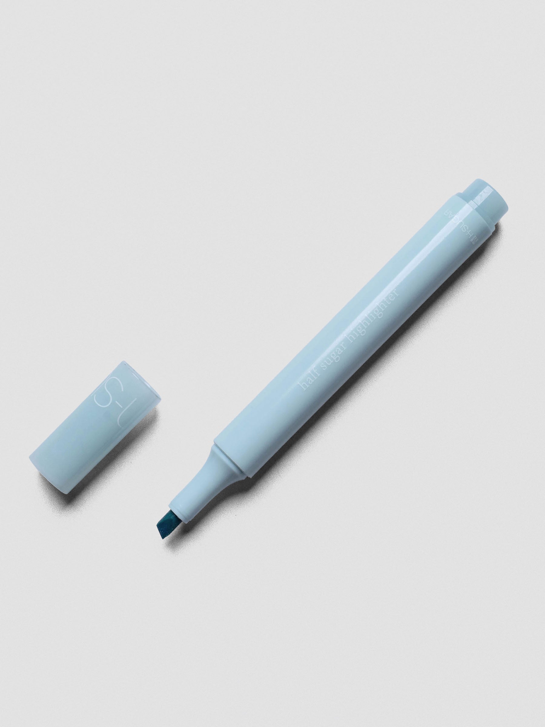 Half Sugar Highlighters shown in Blue with cap off beside the body of the highlighter.