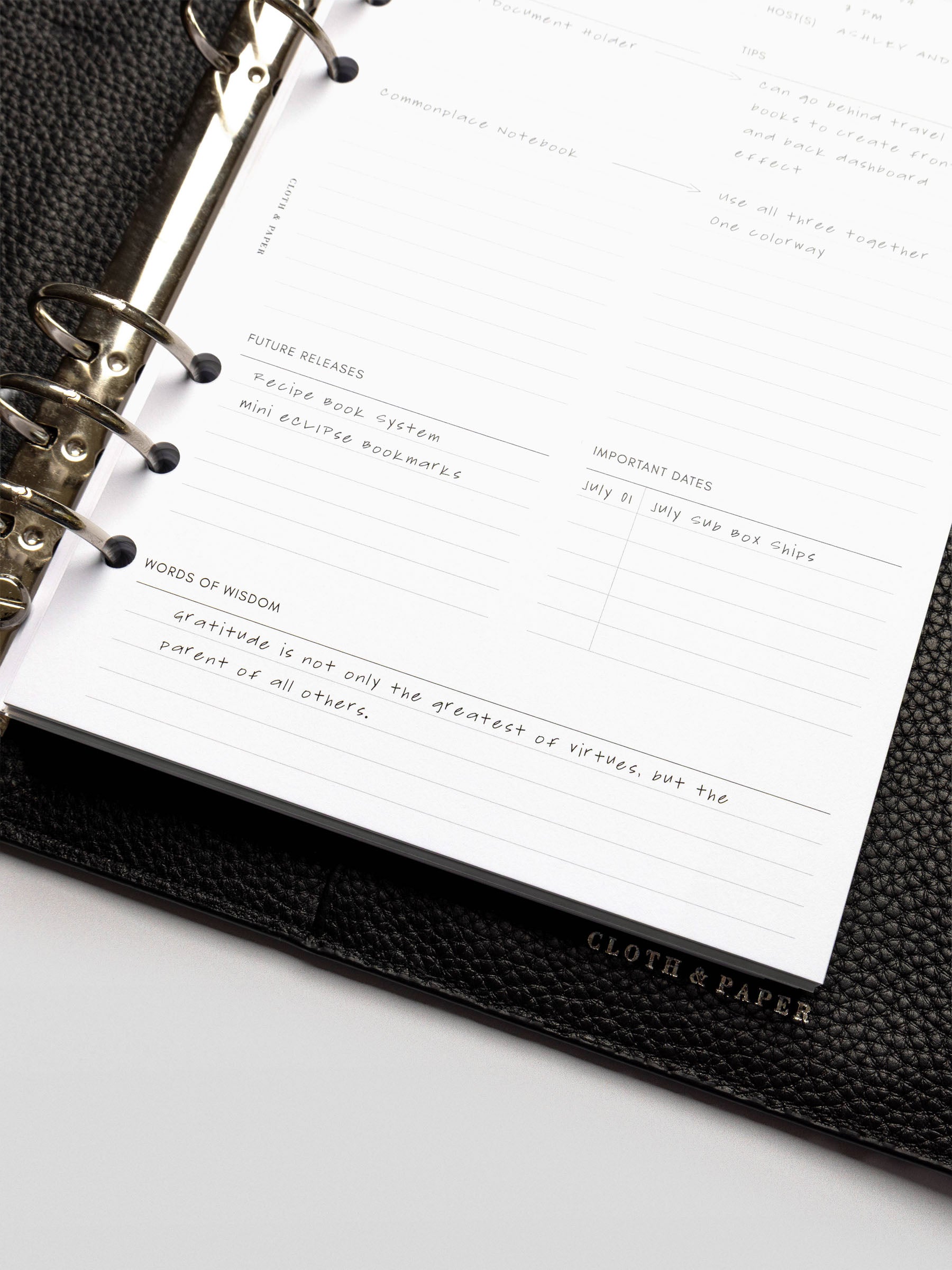 Close-up of handwritten notes on a Happy Hour Notes Insert detailing future releases and a gratitude quote.