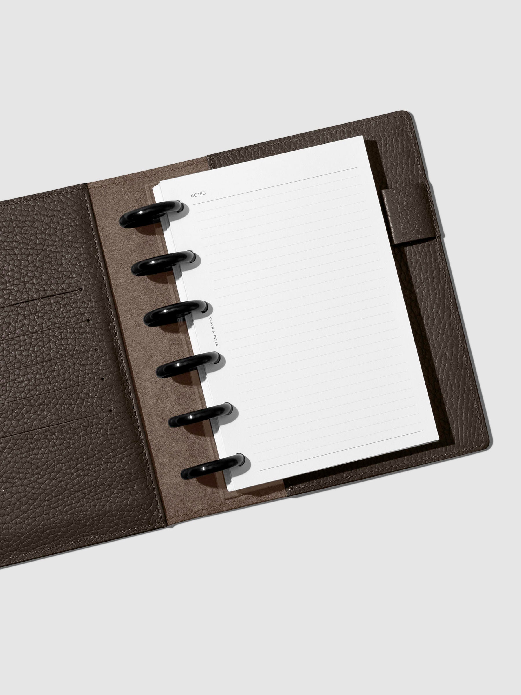 Folio displayed opened on a neutral background.