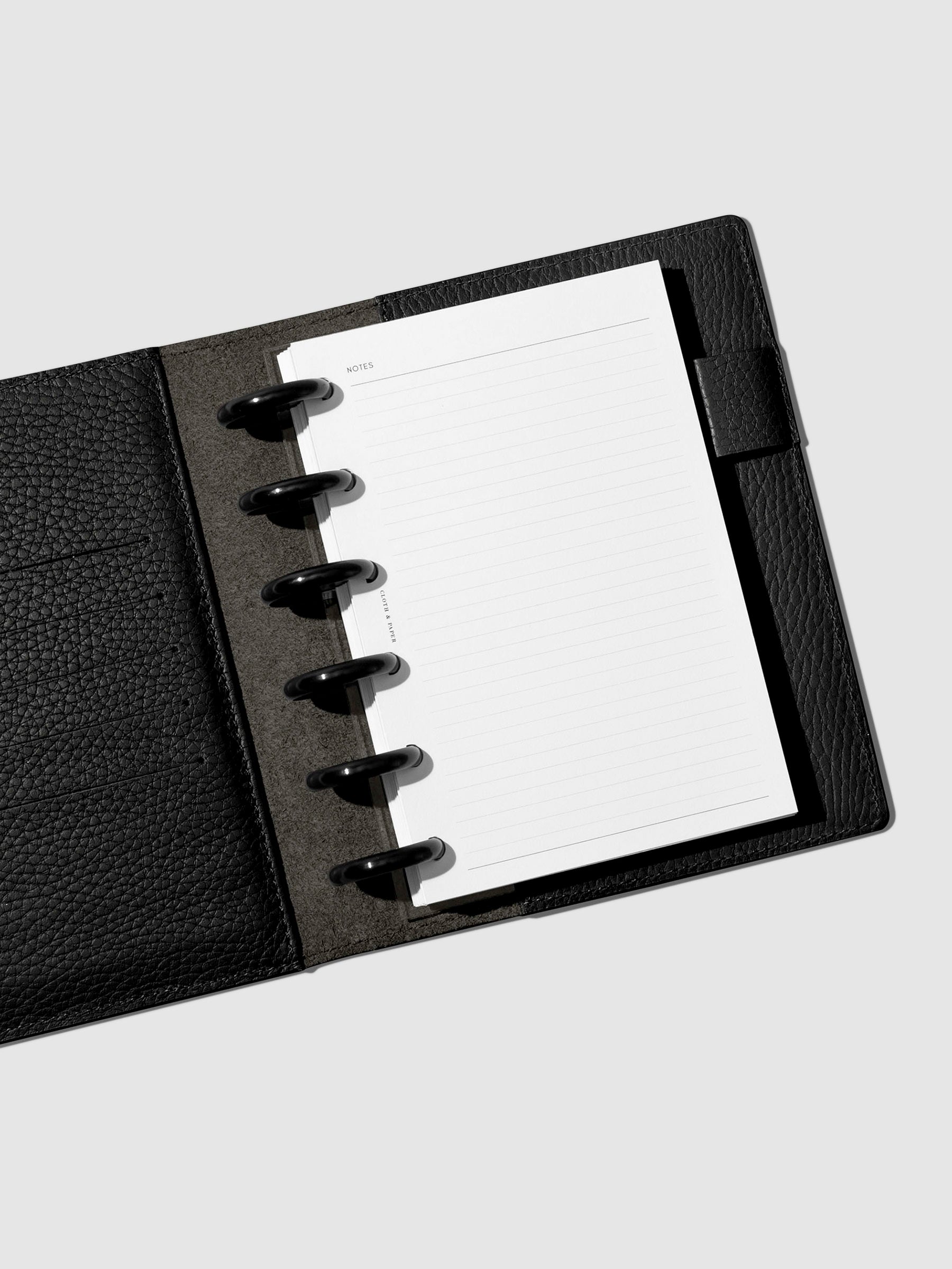 Folio displayed opened on a neutral background.