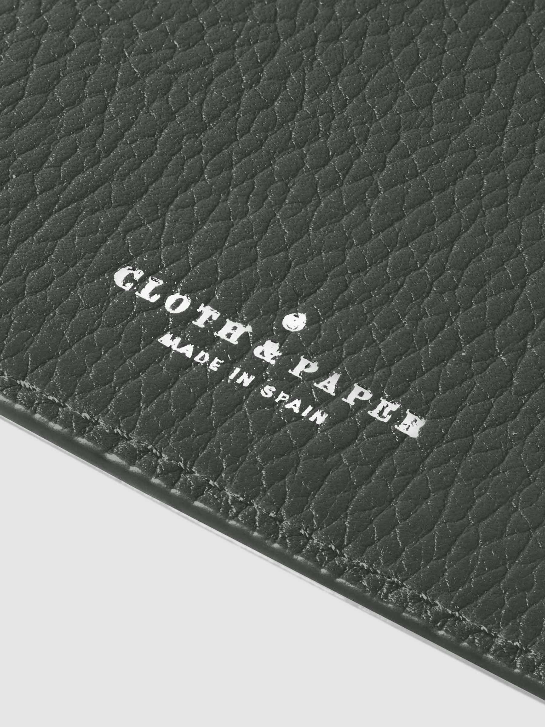 Closeup of silver stamping on leather folio.