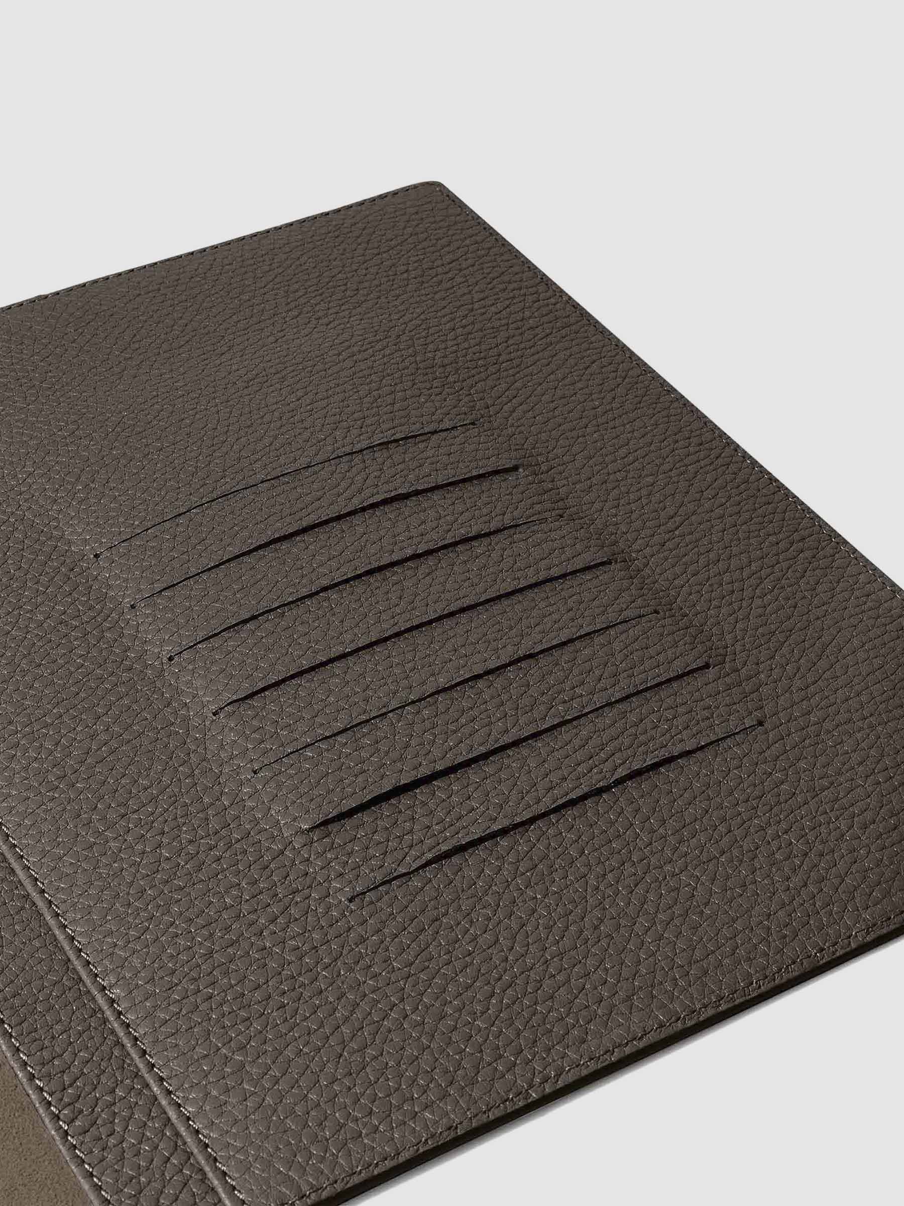 Closeup of credit card slots inside leather folio.