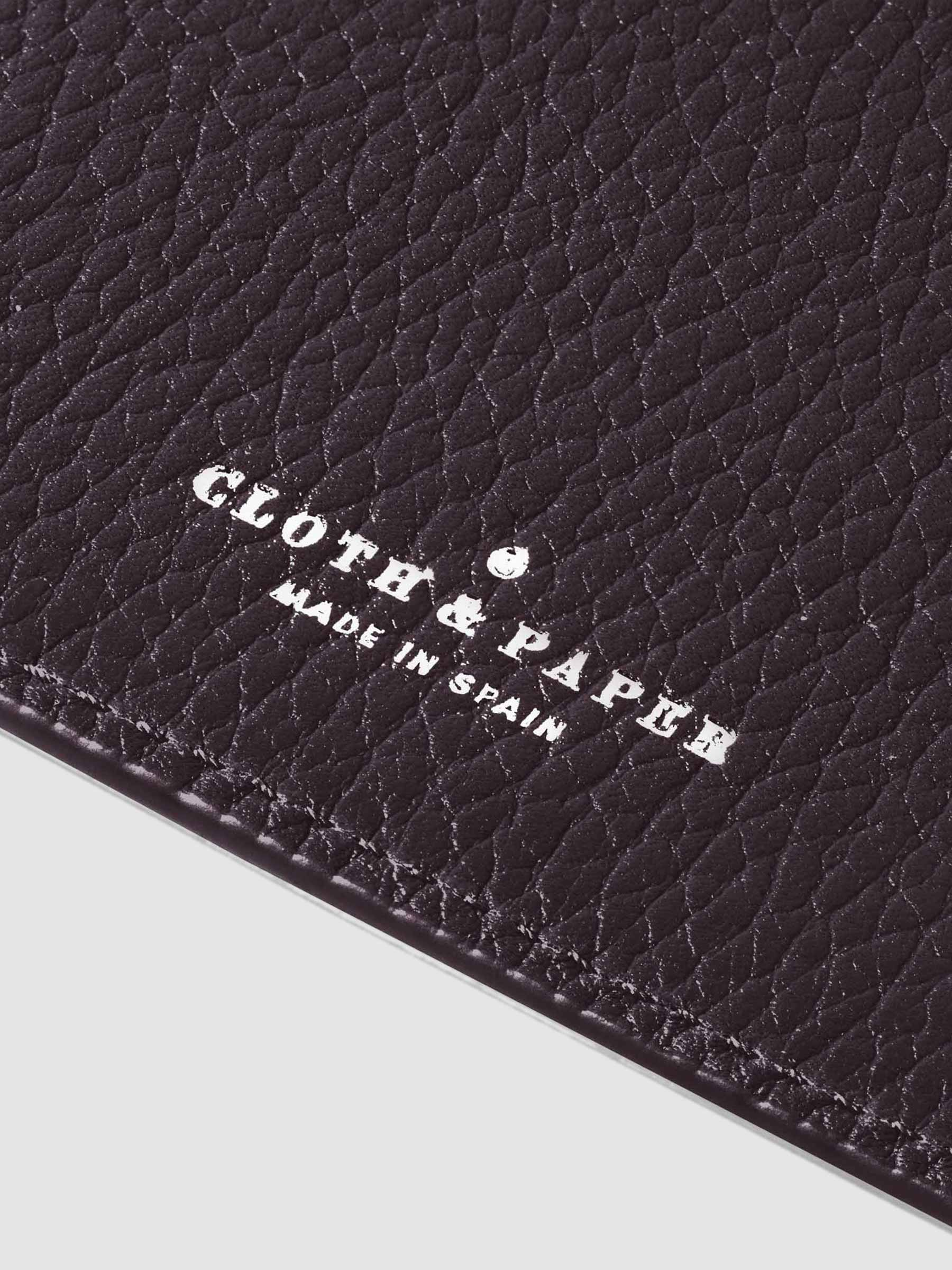 Closeup of silver stamping on leather folio.